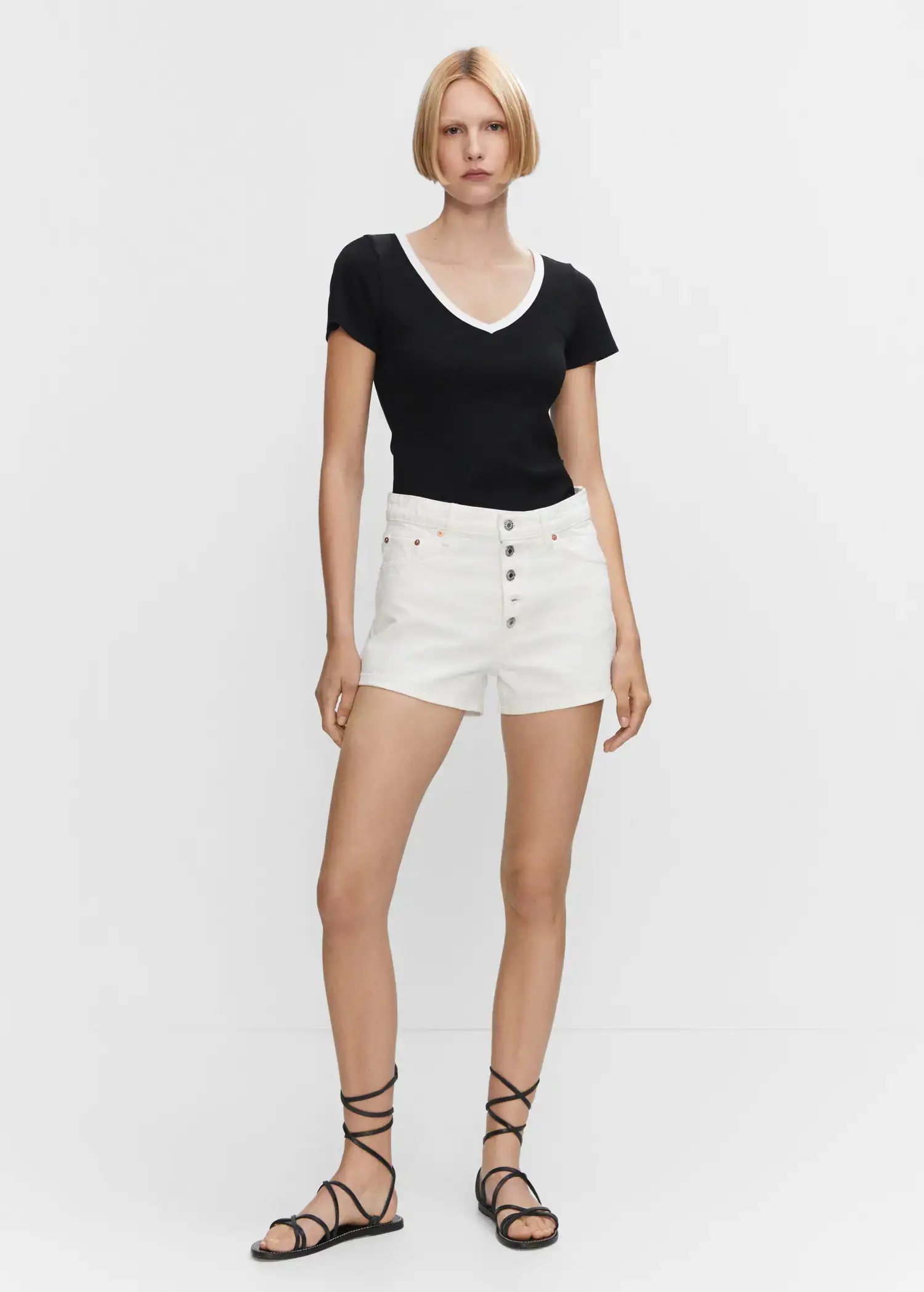 Mango Contrast collar shirt. a woman in black shirt and white shorts. 