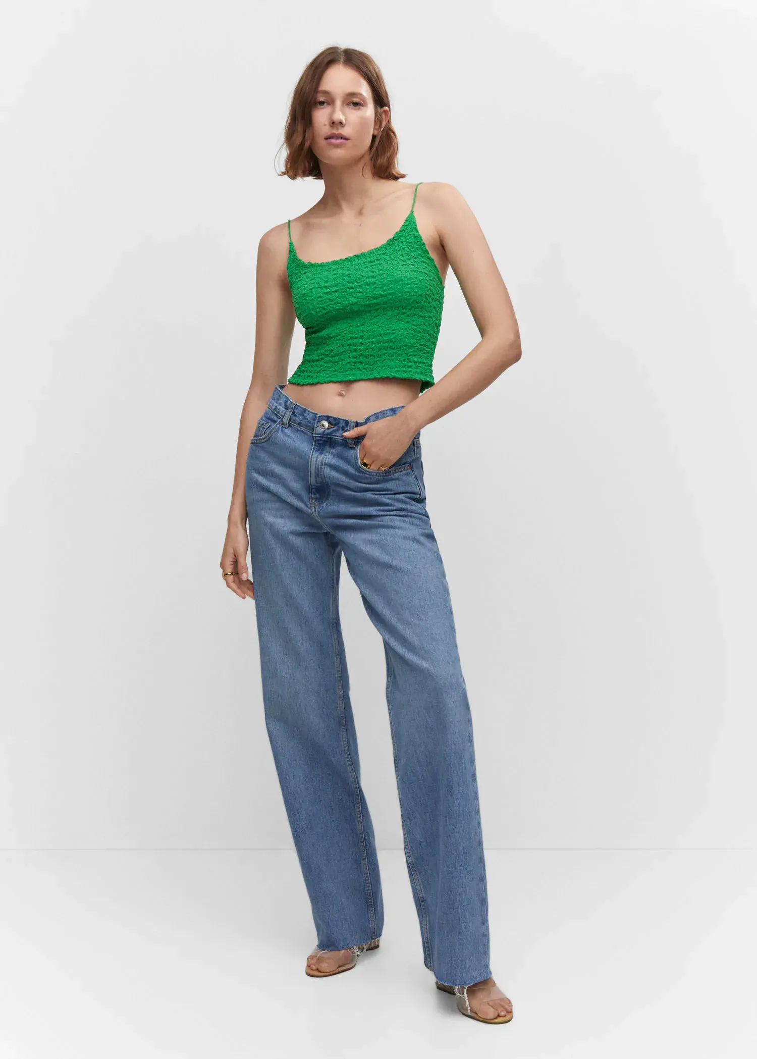 Mango Textured crop top. a woman in a green top and blue jeans. 