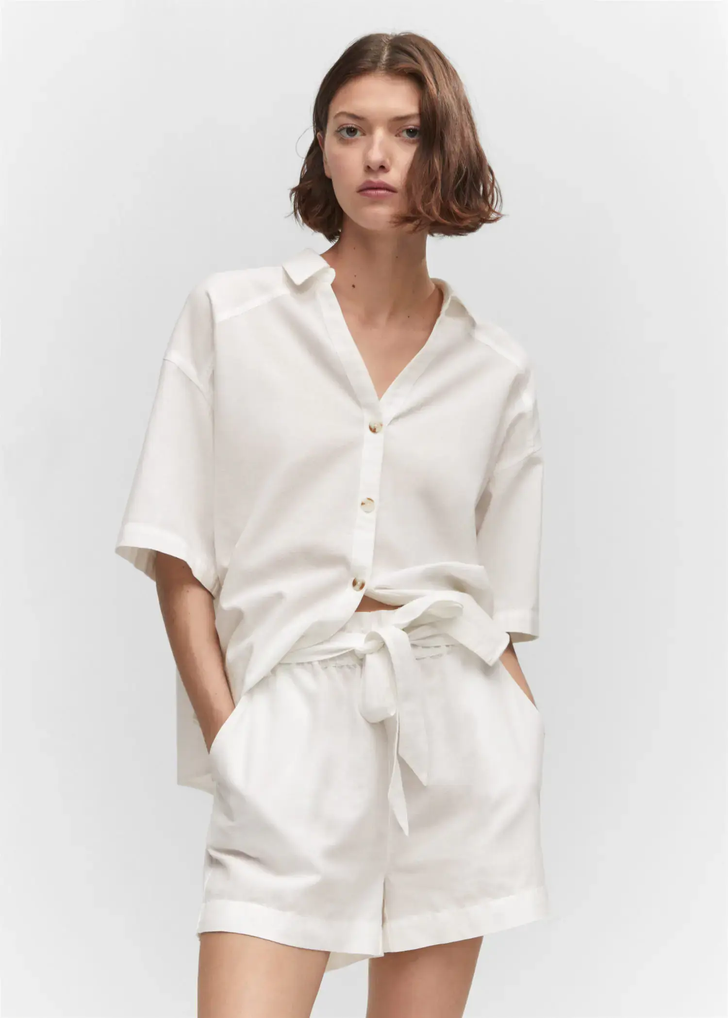 Mango Cotton linen-blend shirt. a woman wearing a white shirt and white shorts. 