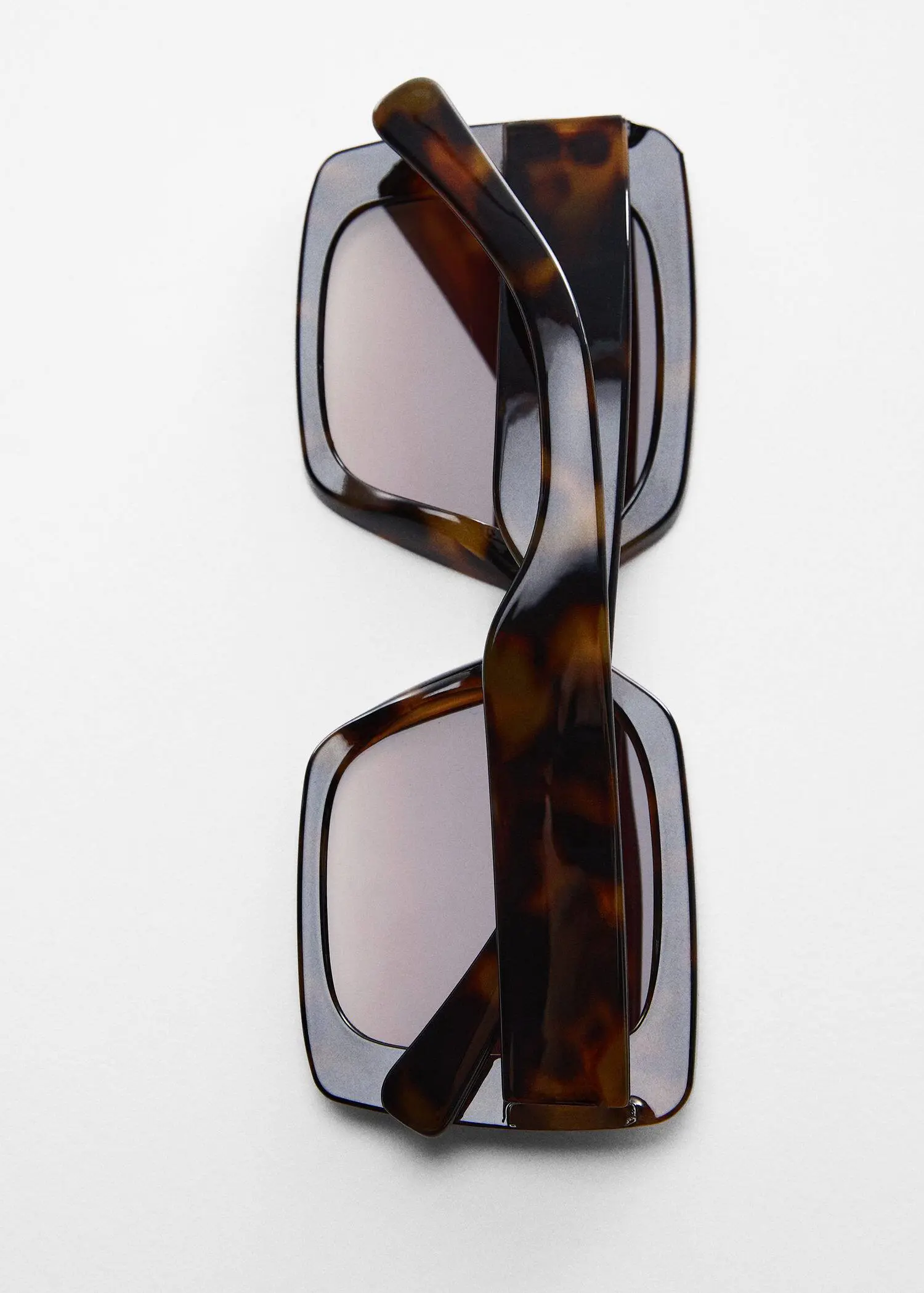 Mango Tortoiseshell square sunglasses. a pair of sunglasses on top of a white surface. 