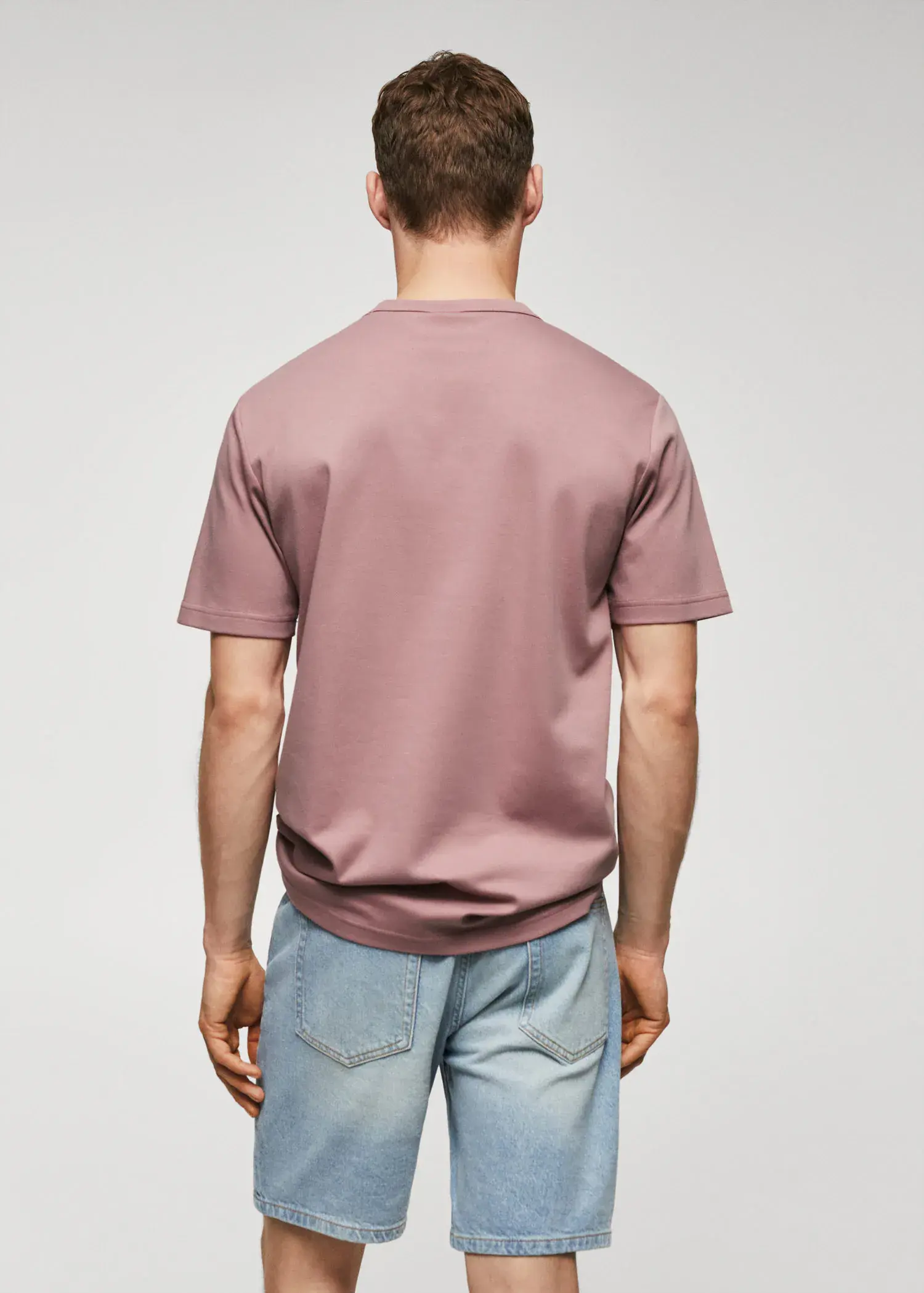 Mango 100% cotton t-shirt with pocket. a man wearing a pink shirt and jeans. 