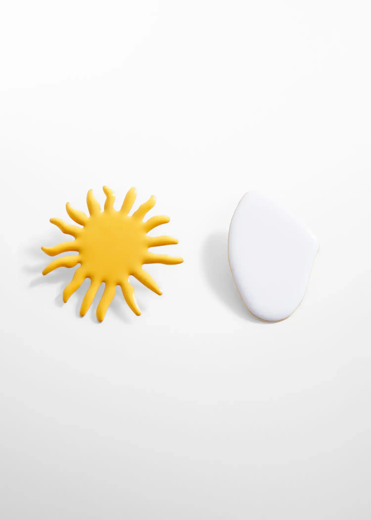 Mango Mixed pieces earrings. a sun and an egg on a white surface. 