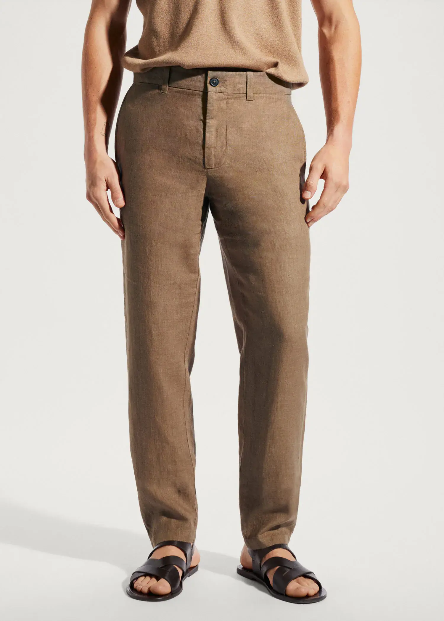 Mango Slim-fit 100% linen trousers. a man wearing a pair of brown pants. 