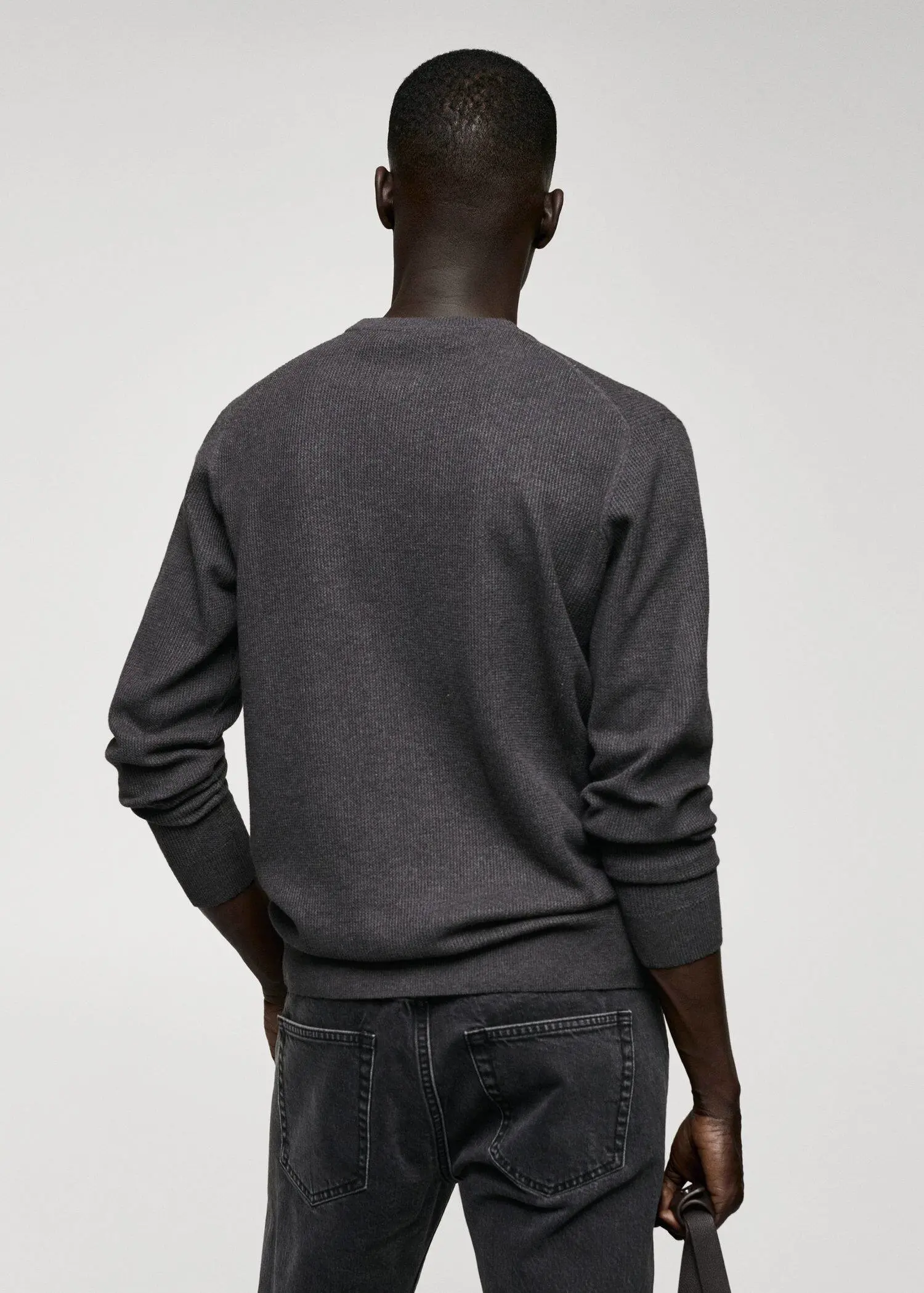 Mango Structured cotton sweater. a man wearing a gray sweater and jeans. 
