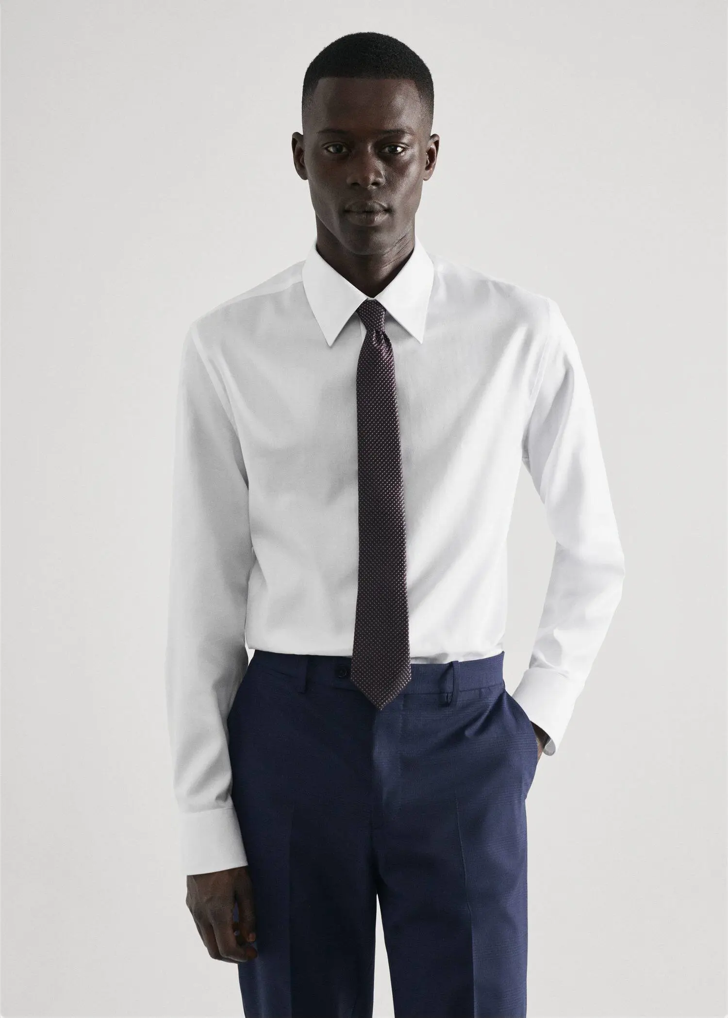 Mango Regular-fit structured suit shirt. a man in a white shirt and a black tie. 