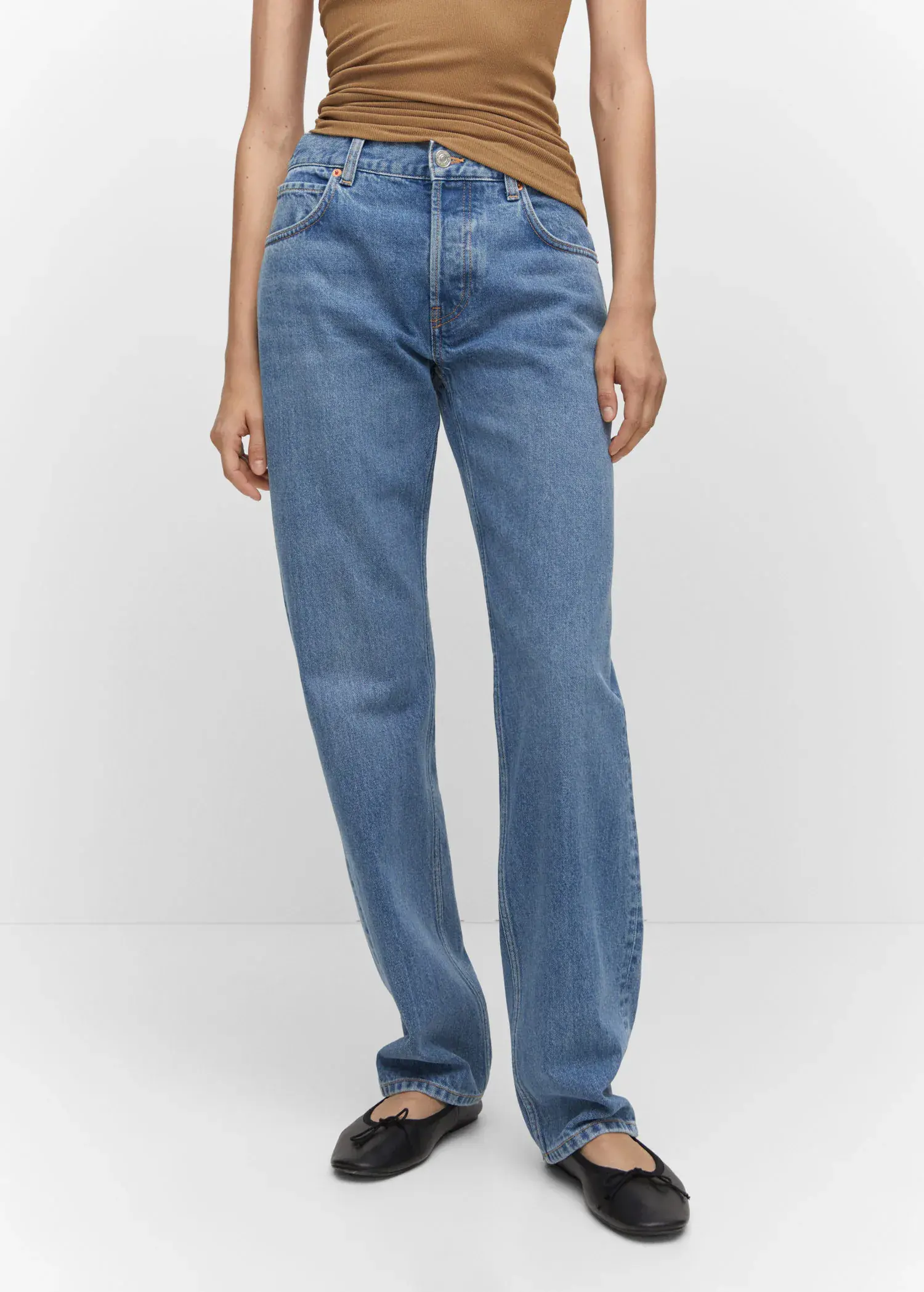 Mango Mid-rise straight jeans. a person standing in a pair of blue jeans. 