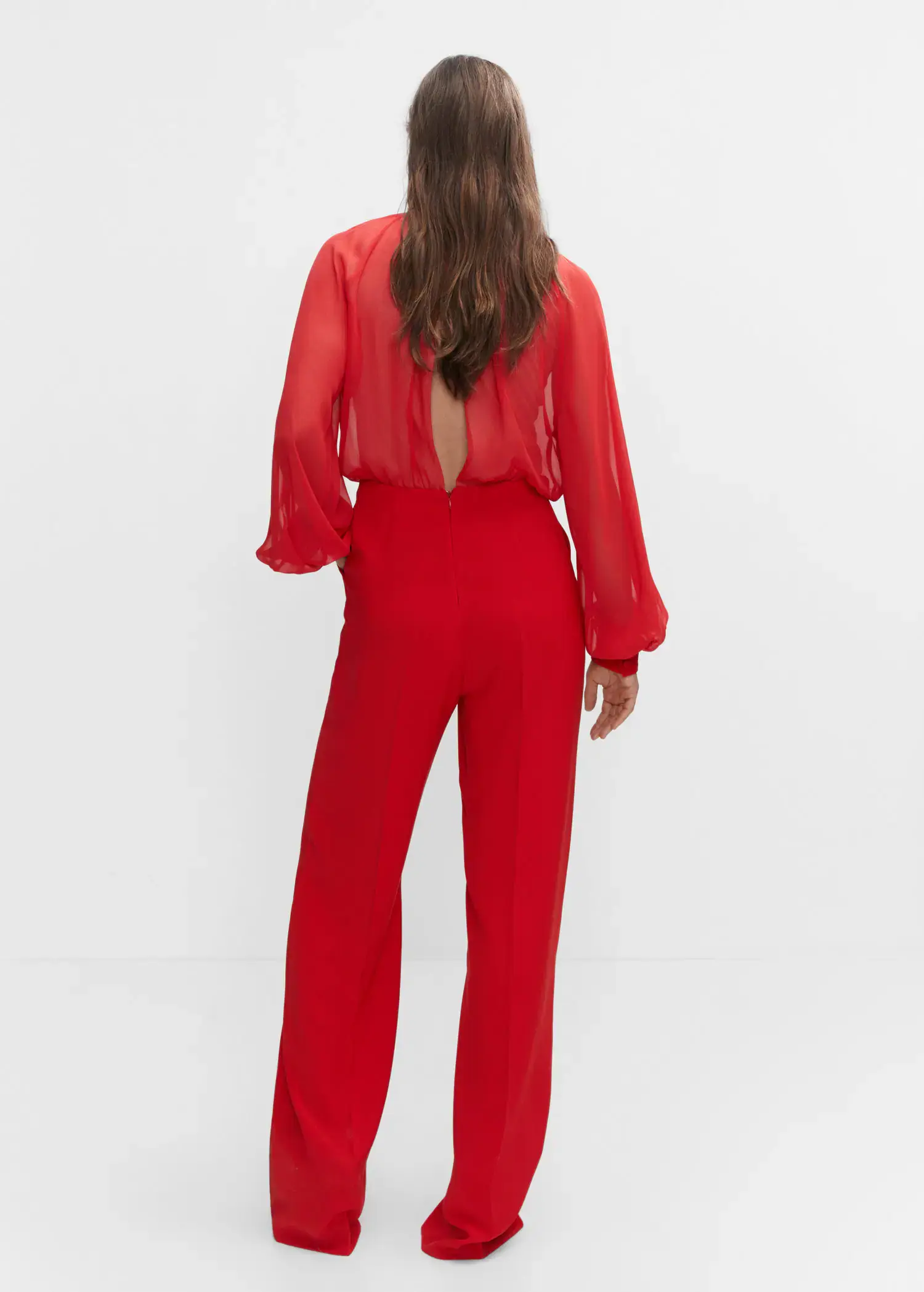 Mango Semi-transparent chiffon jumpsuit. a woman in a red outfit standing in front of a white wall. 