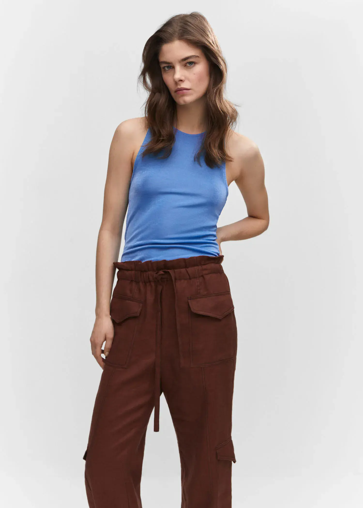 Mango Strap top. a woman in a blue shirt and brown pants. 
