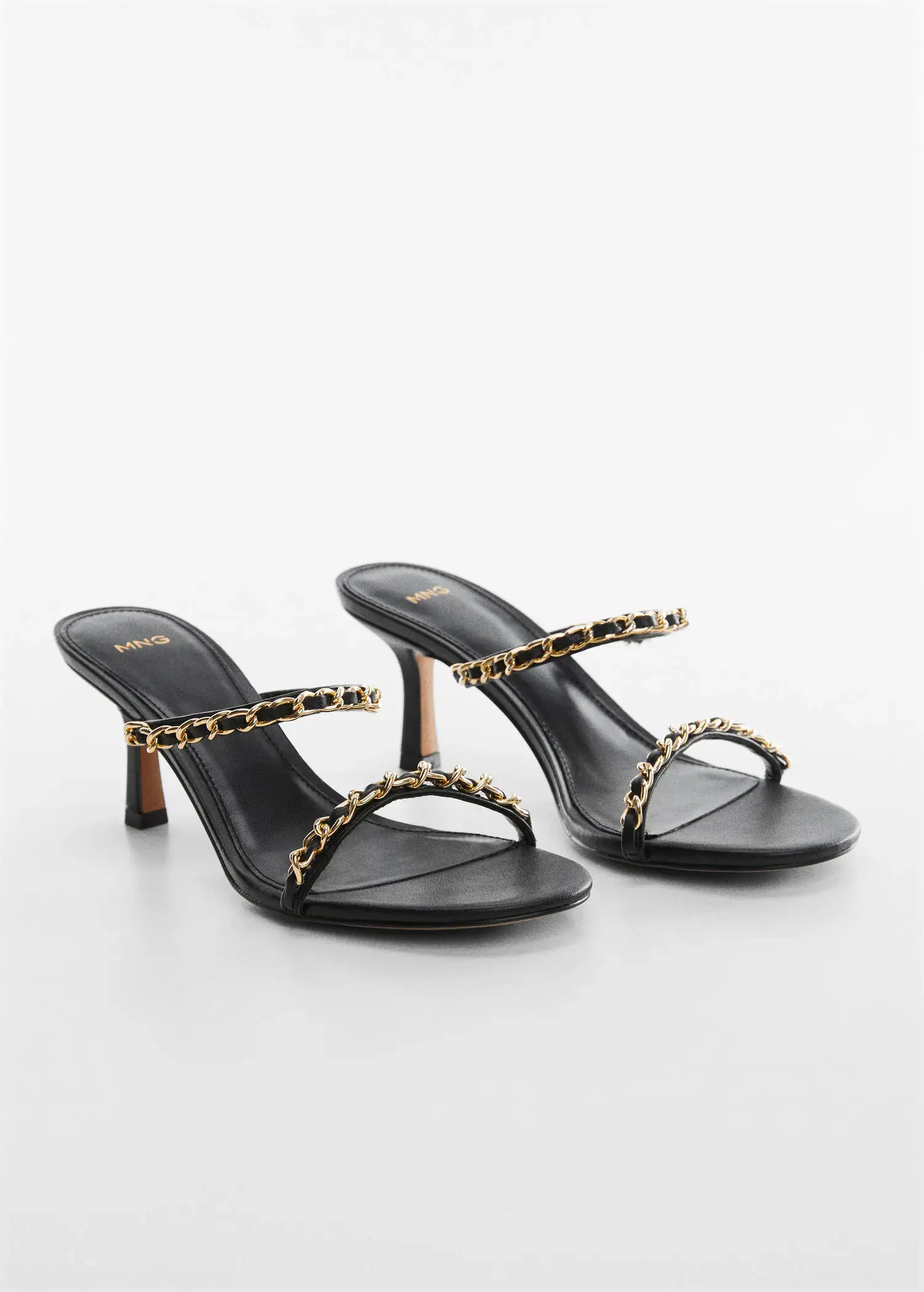 Mango High-heeled sandals with chain detail. a pair of black sandals with a leopard print strap. 