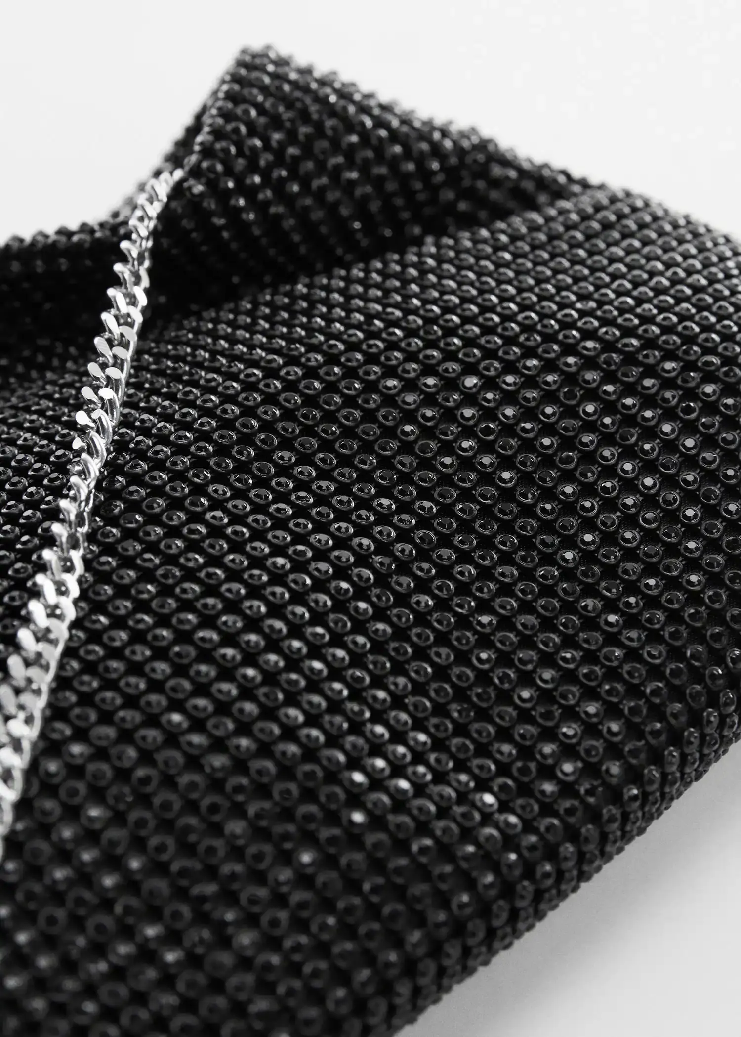Mango Rhinestone chain bag. a close-up view of a black and silver purse. 