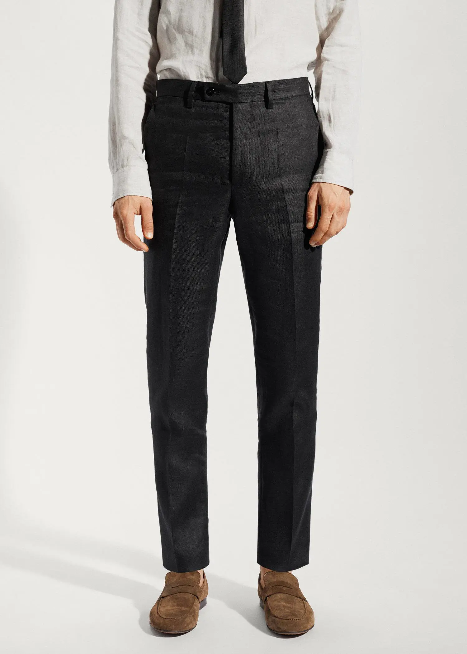 Mango 100% linen suit trousers. a man wearing a white shirt and black pants. 