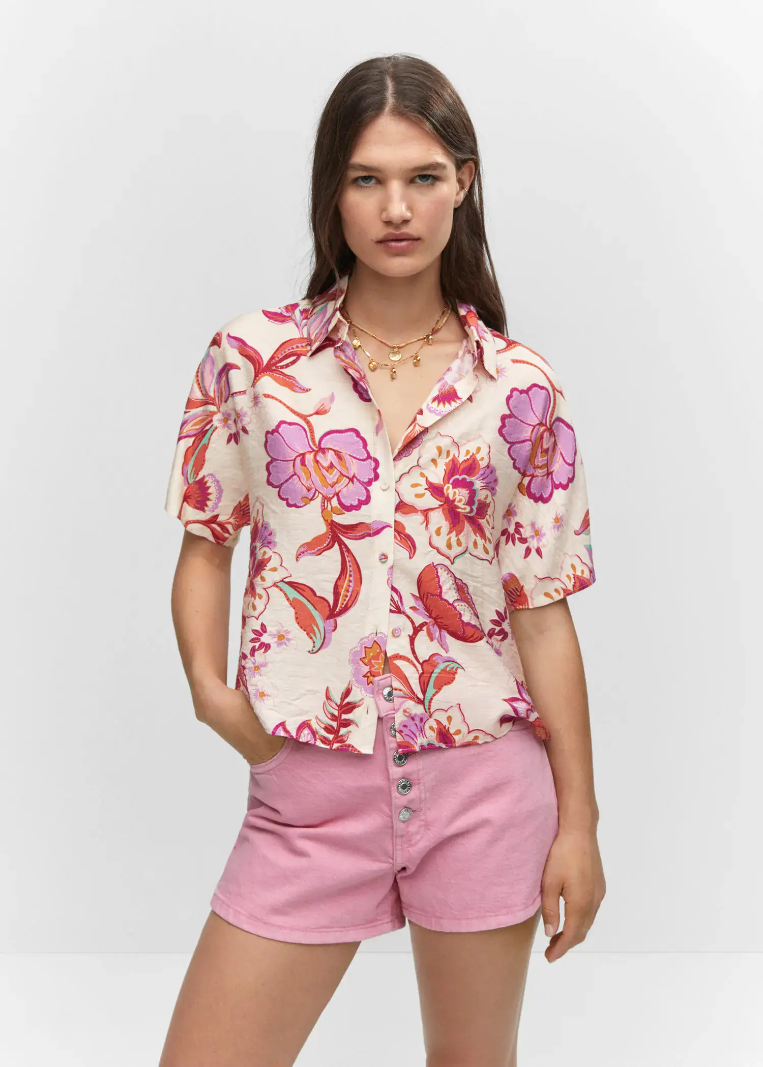 Mango Buttoned printed shirt. a woman wearing a floral shirt and pink shorts. 