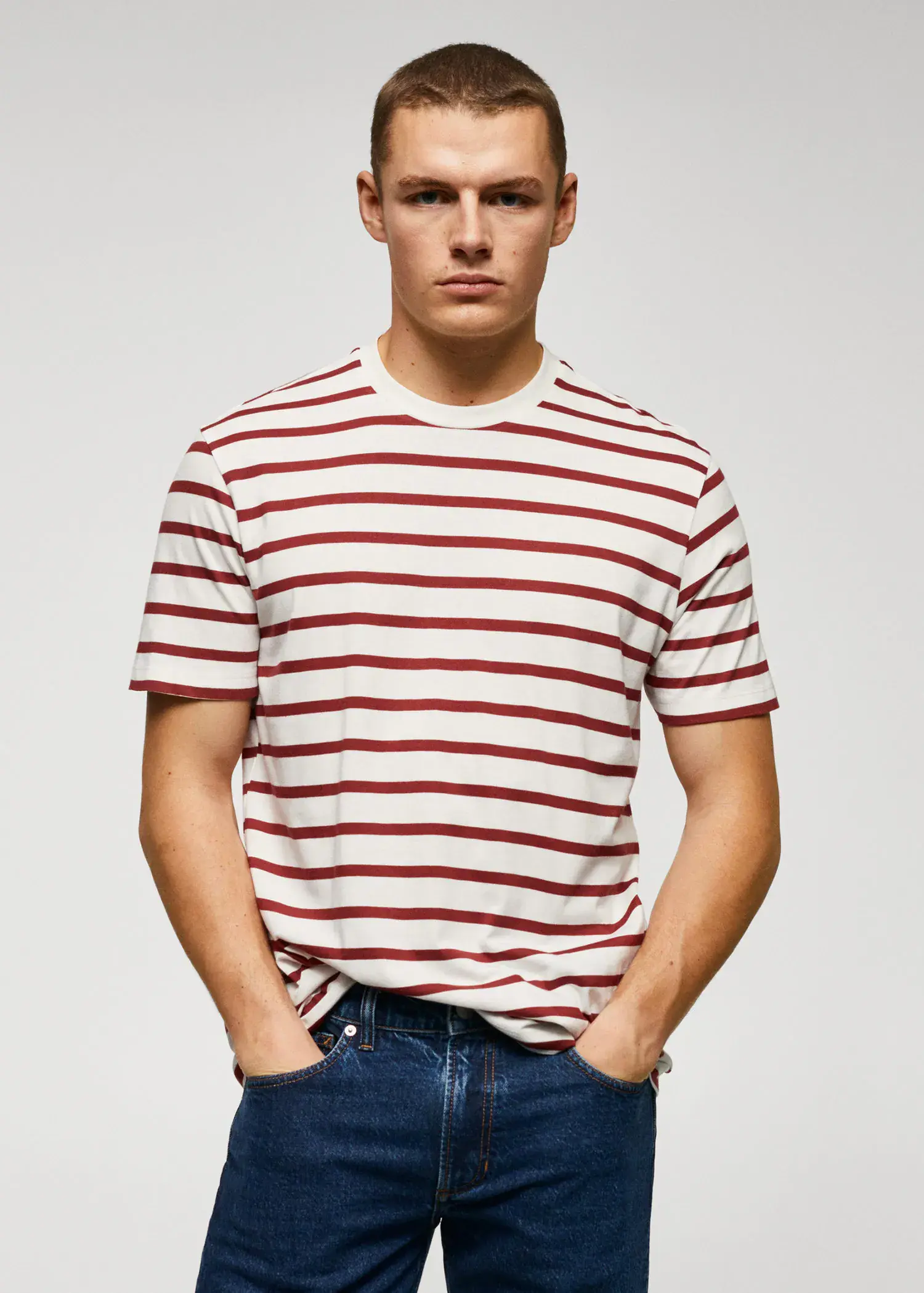 Mango Cotton-modal striped t-shirt. a young man wearing a striped t-shirt and jeans. 