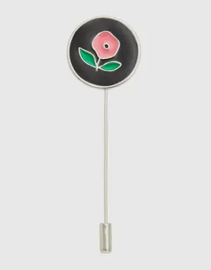 black brooch with pink flower