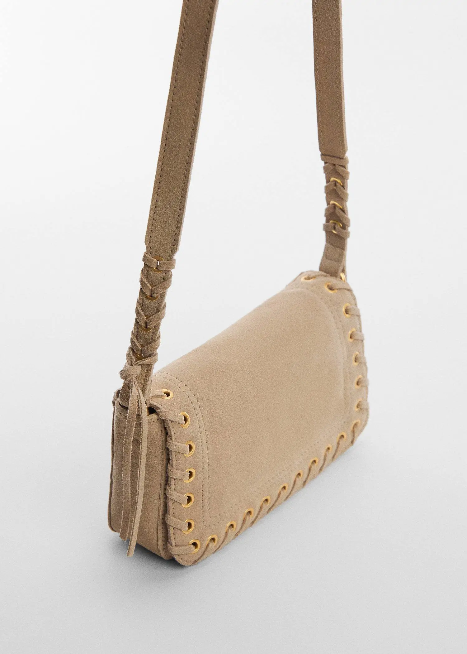 Mango Stud leather bag. a beige purse is shown on a white surface. 