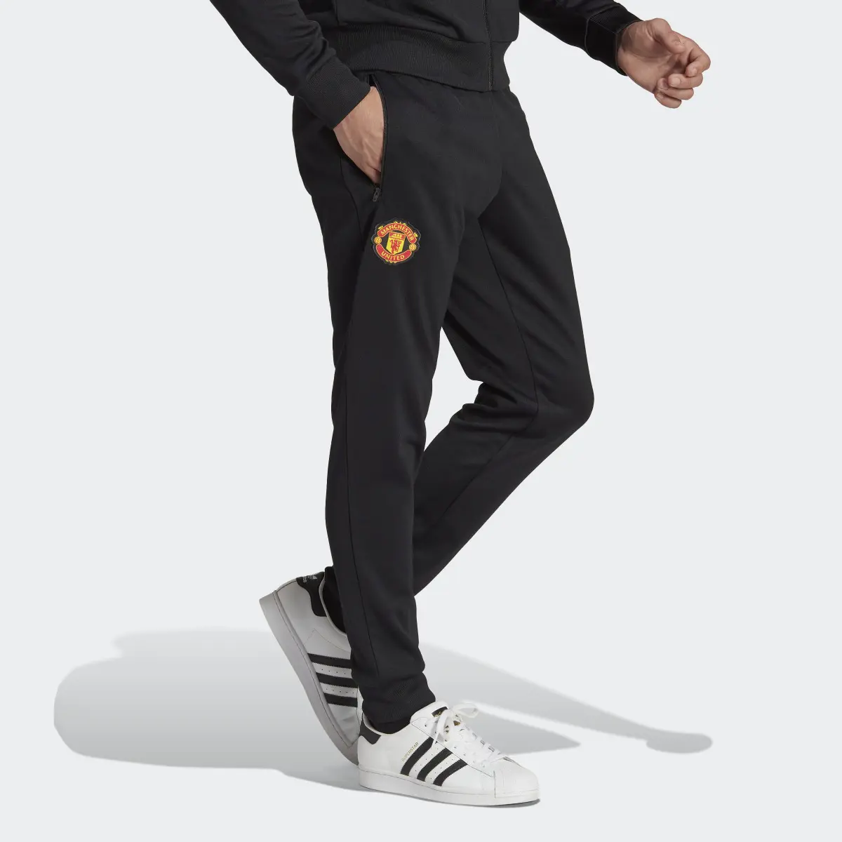 Adidas Manchester United Essentials Trefoil Joggers. 1