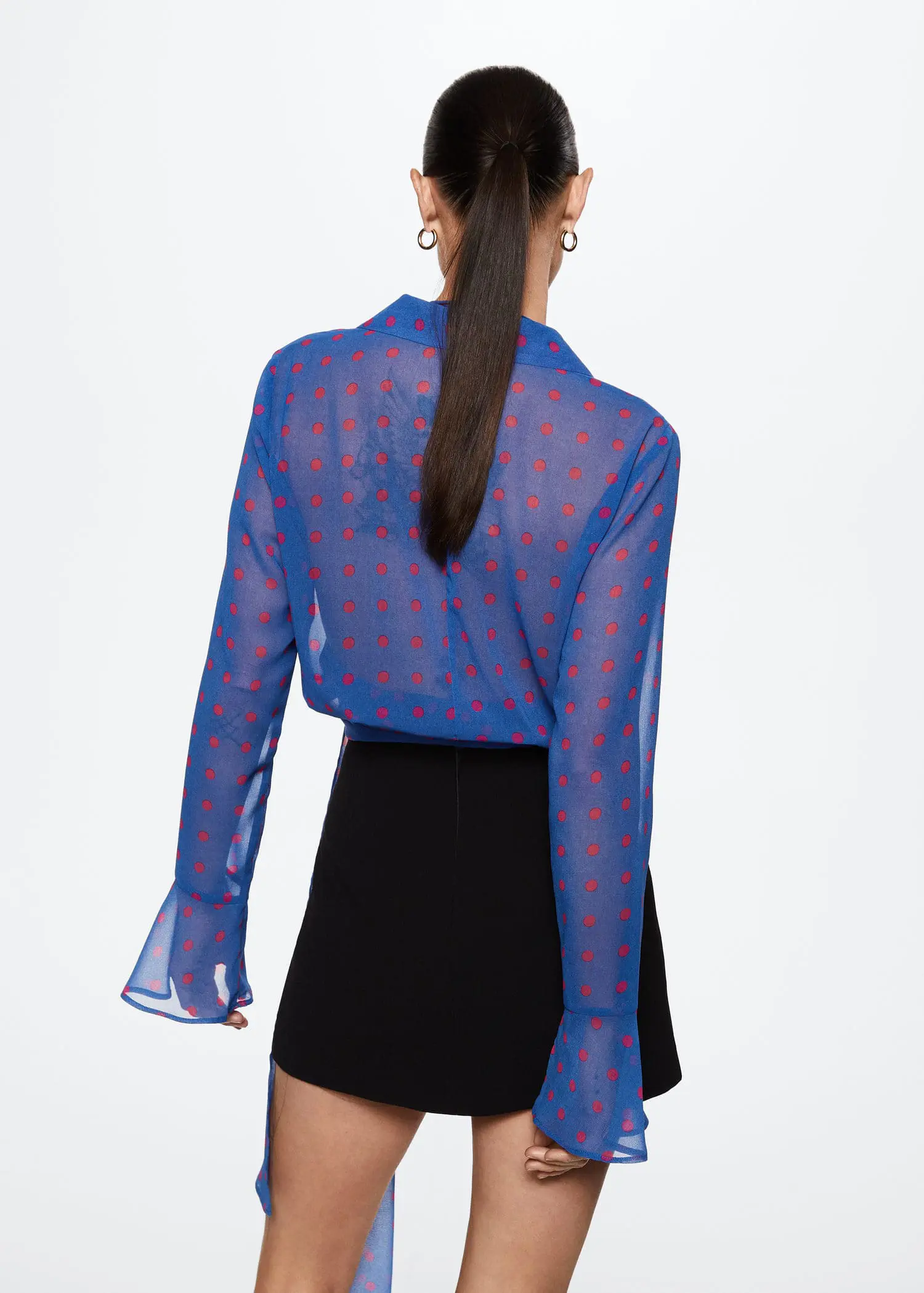 Mango Sheer polka-dot blouse. a woman wearing a blue and red polka dot shirt. 