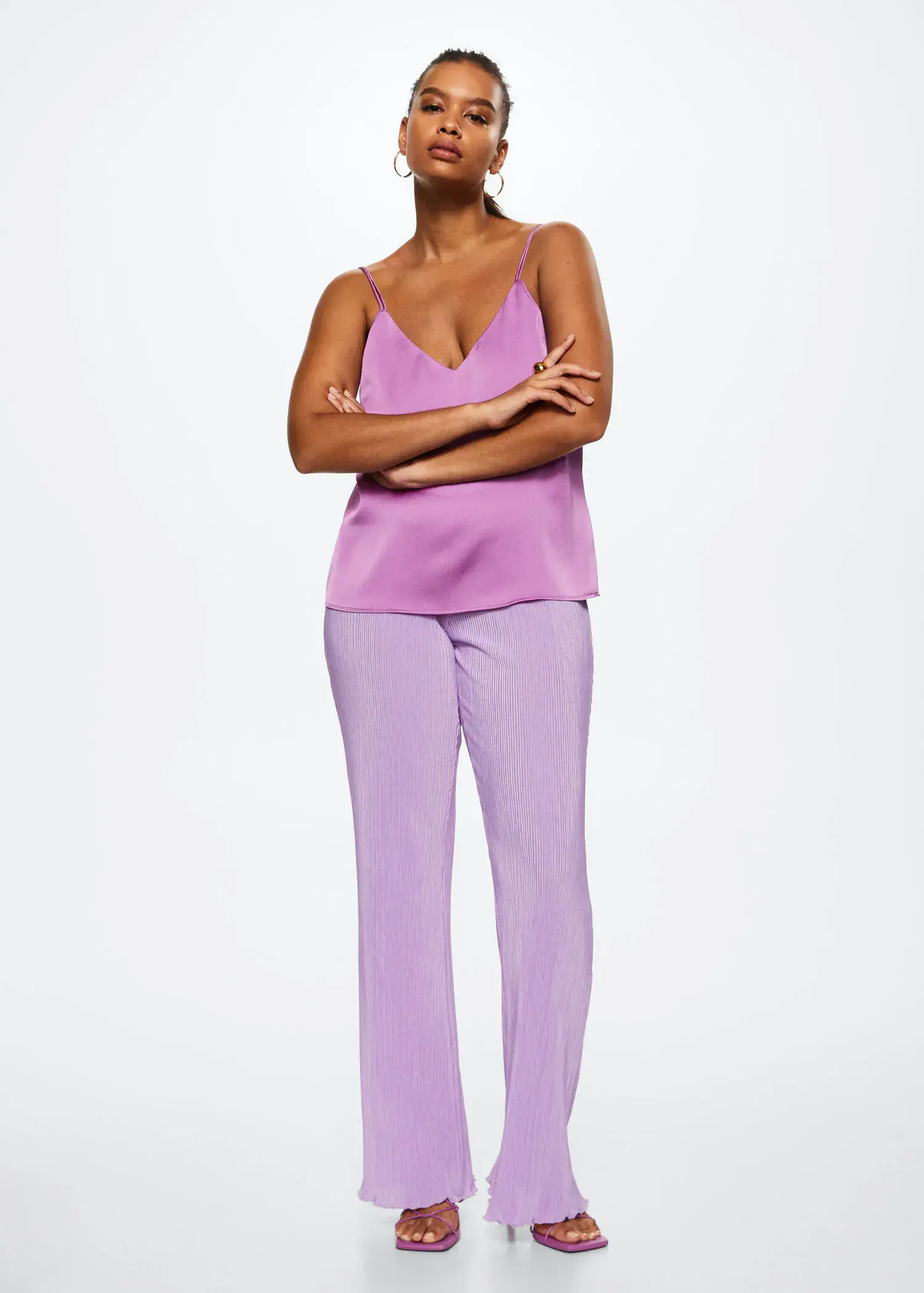 Mango Satin lace top. a woman standing in a purple outfit with her arms crossed. 