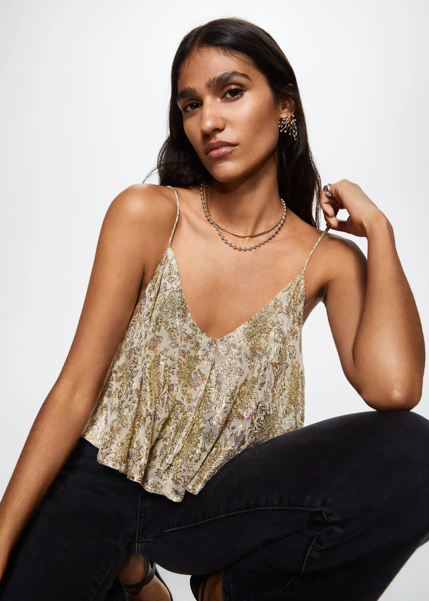 Mango Lurex crop top. a woman sitting on the ground wearing a necklace. 