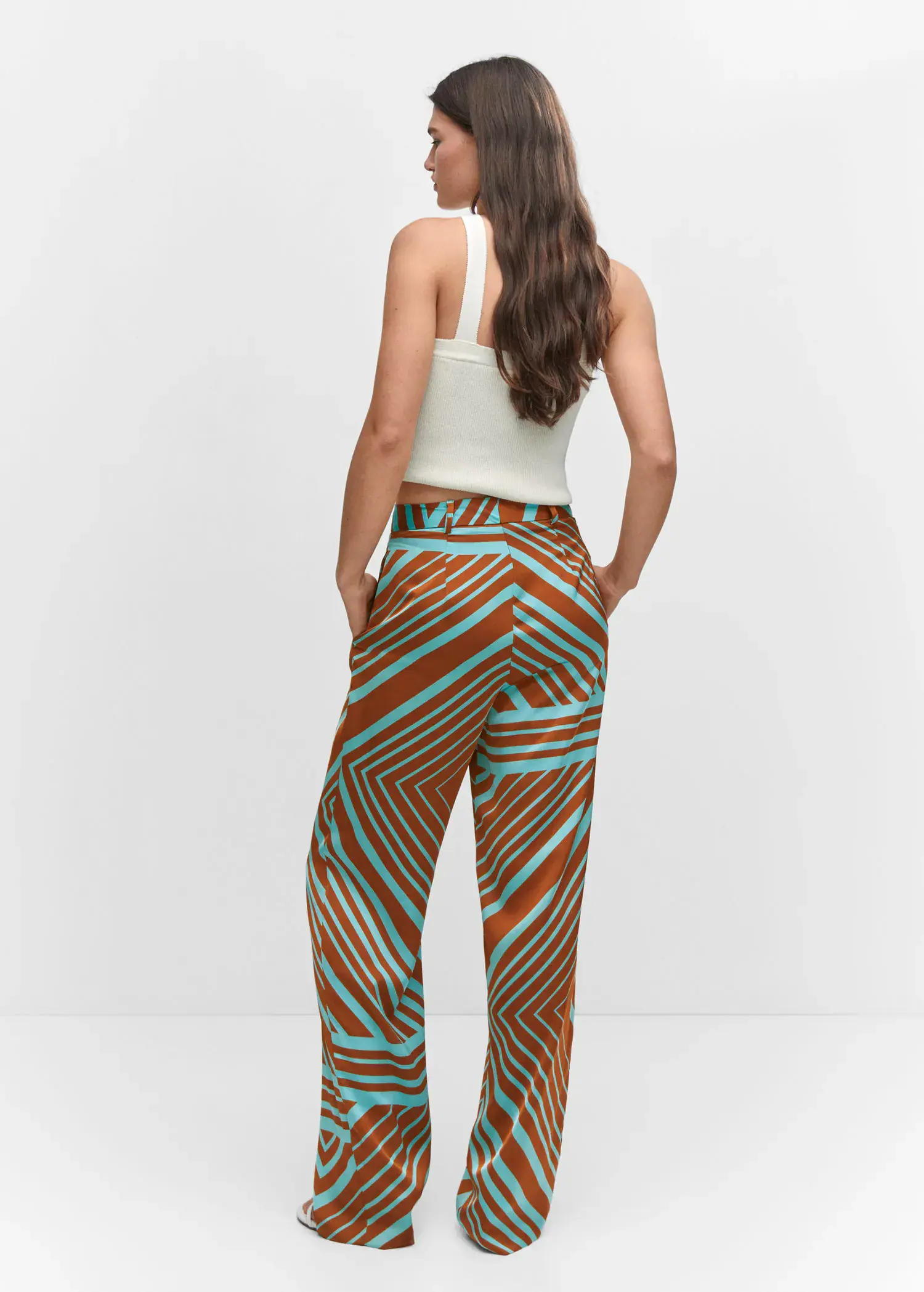 Mango Satin printed trousers. a woman is standing in front of a white wall. 