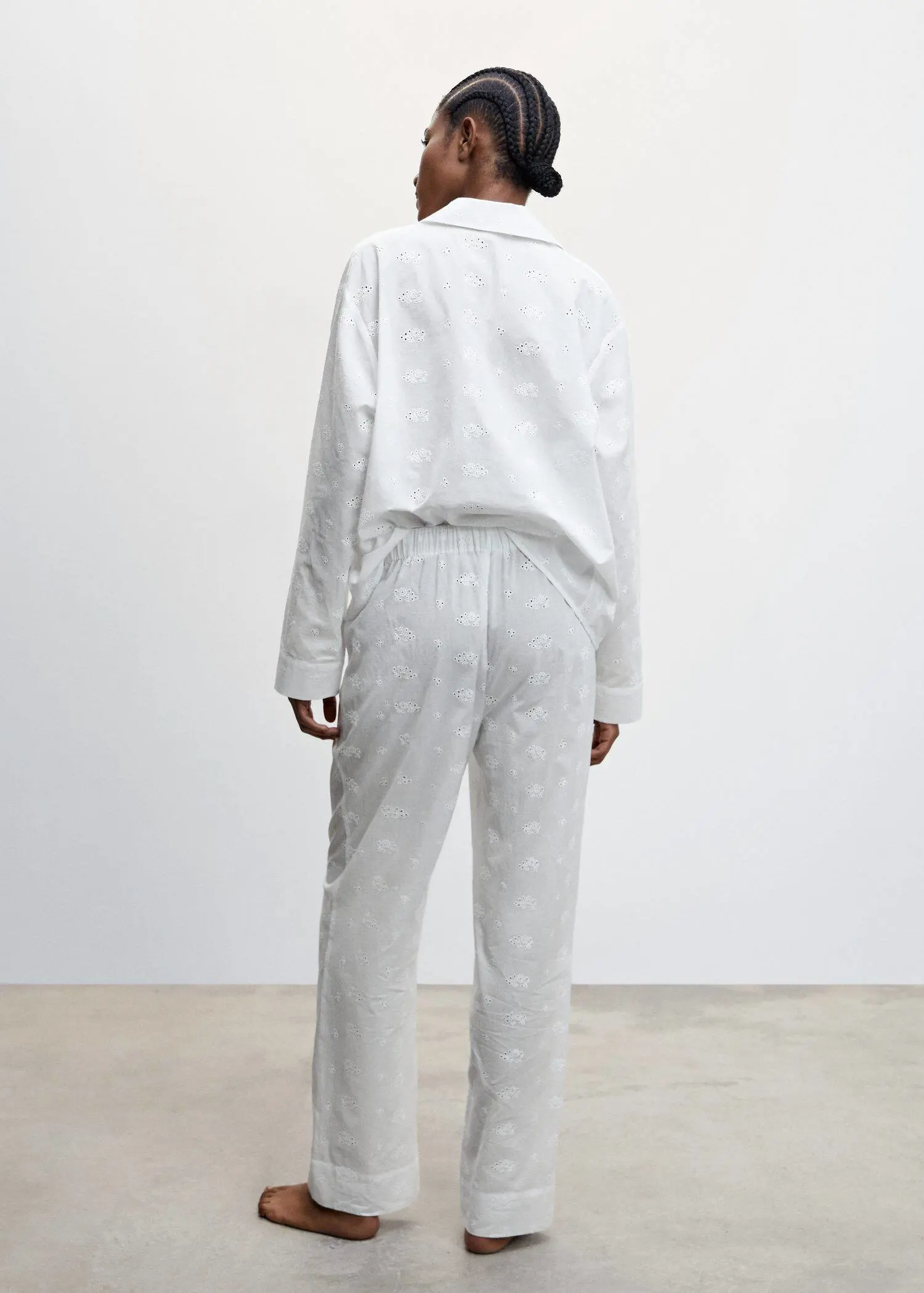 Mango Pyjama trousers with openwork details. a person wearing a white shirt and pants. 