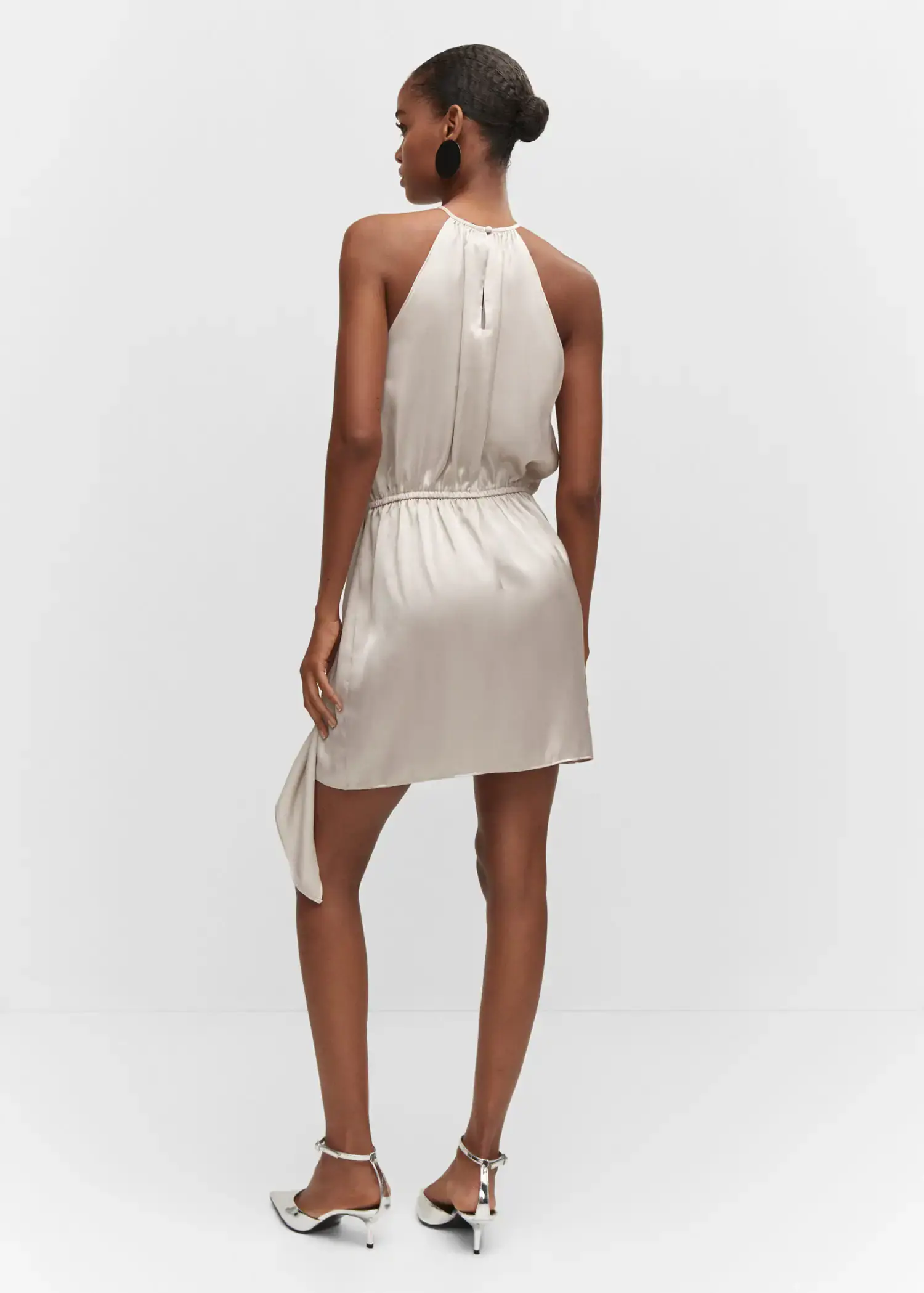 Mango Satin halter neck dress. a woman wearing a white dress standing in a room. 