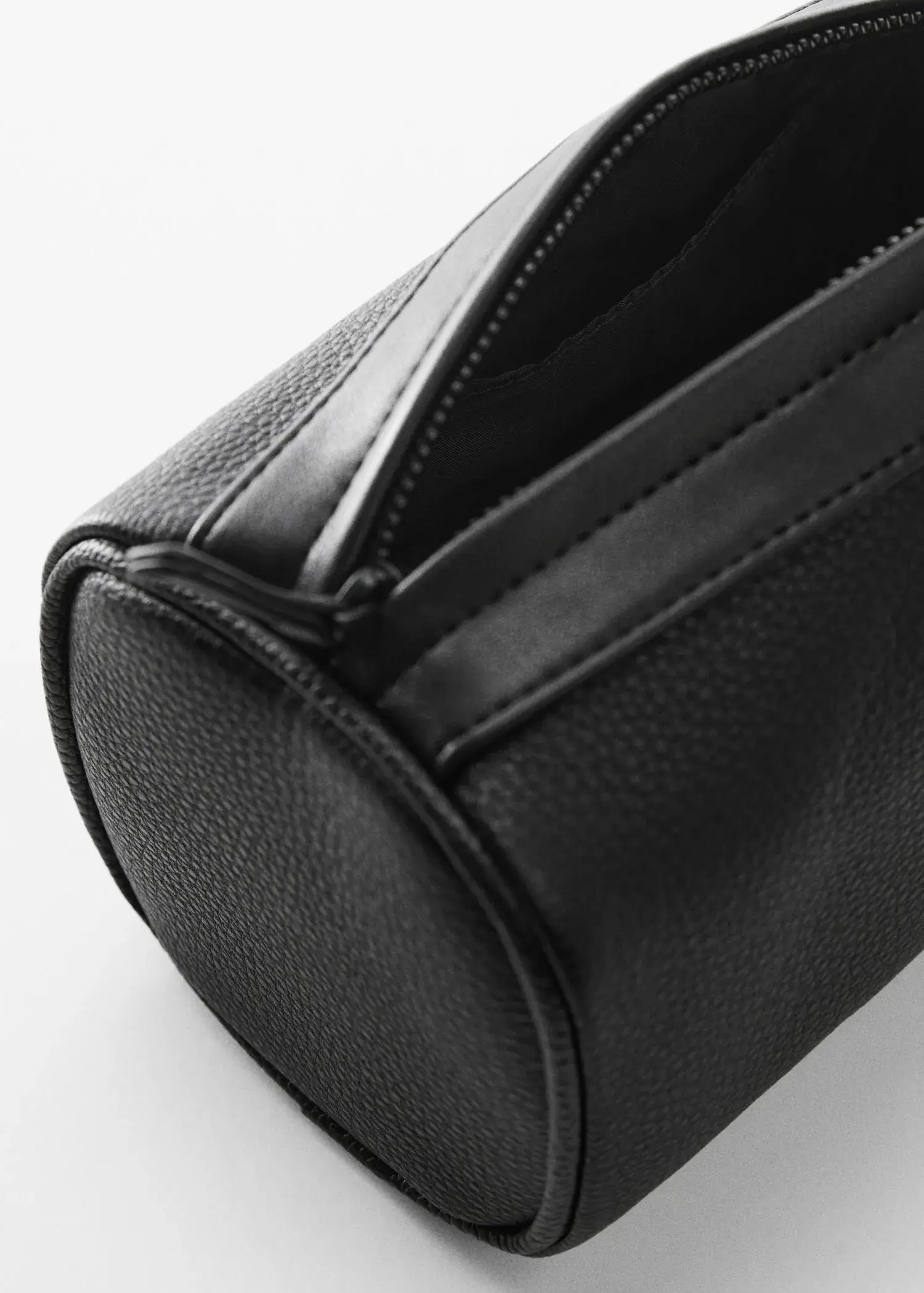 Mango Pebbled leather-effect toiletry bag. a close-up view of the inside of a black purse. 
