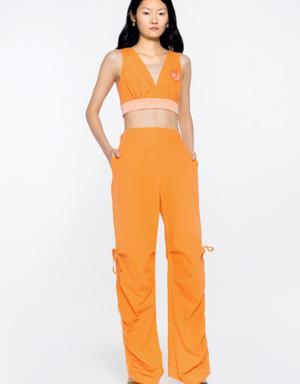 Model Detailed Trotters With Side Seam Slits Shrinkable Back Waistline Shirred Orange Trousers