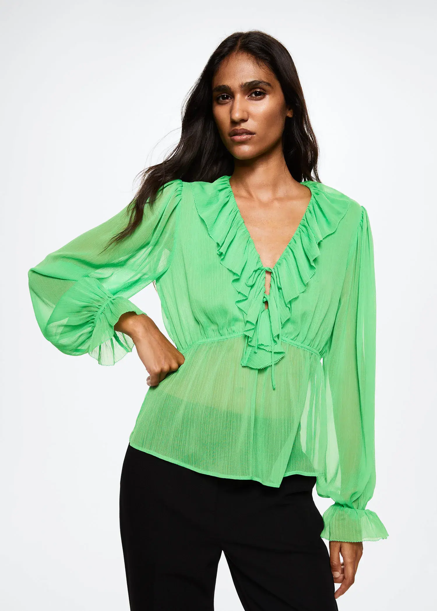 Mango Ruffled neck blouse. a woman wearing a green blouse posing for a picture. 