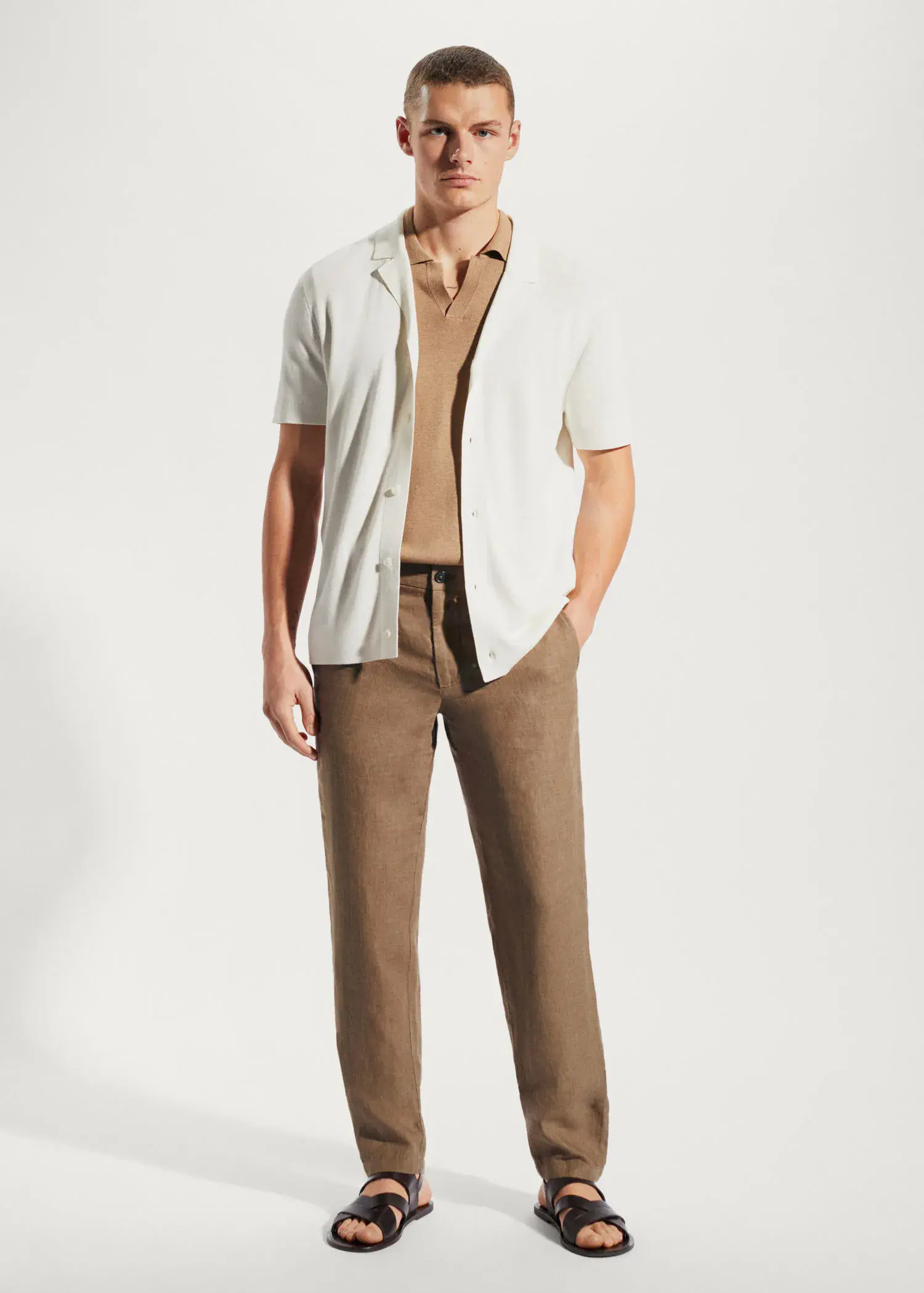 Mango Slim-fit 100% linen trousers. a man in a white shirt and brown pants. 