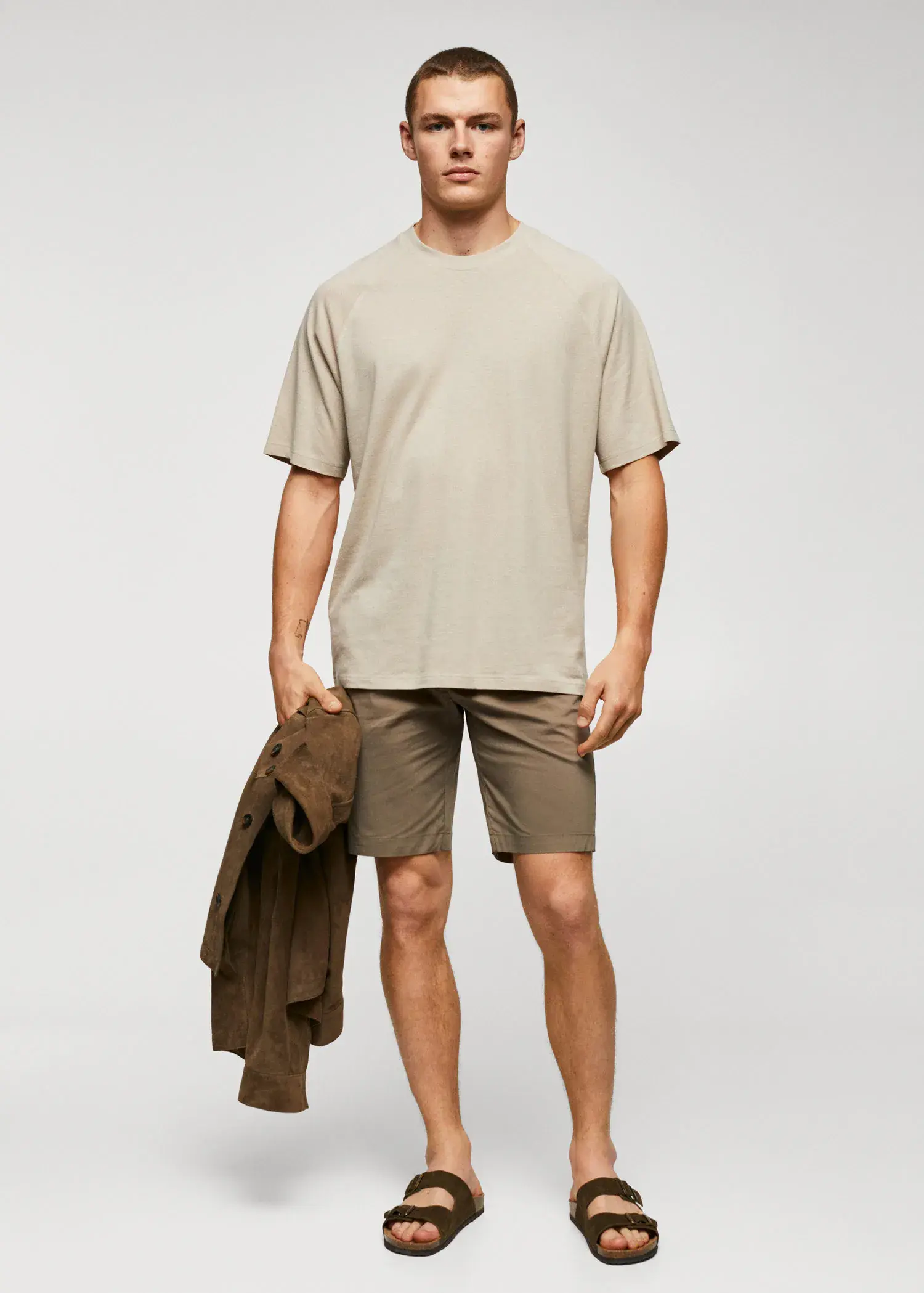 Mango Textured cotton-linen t-shirt. a man in a tan shirt and brown shorts. 