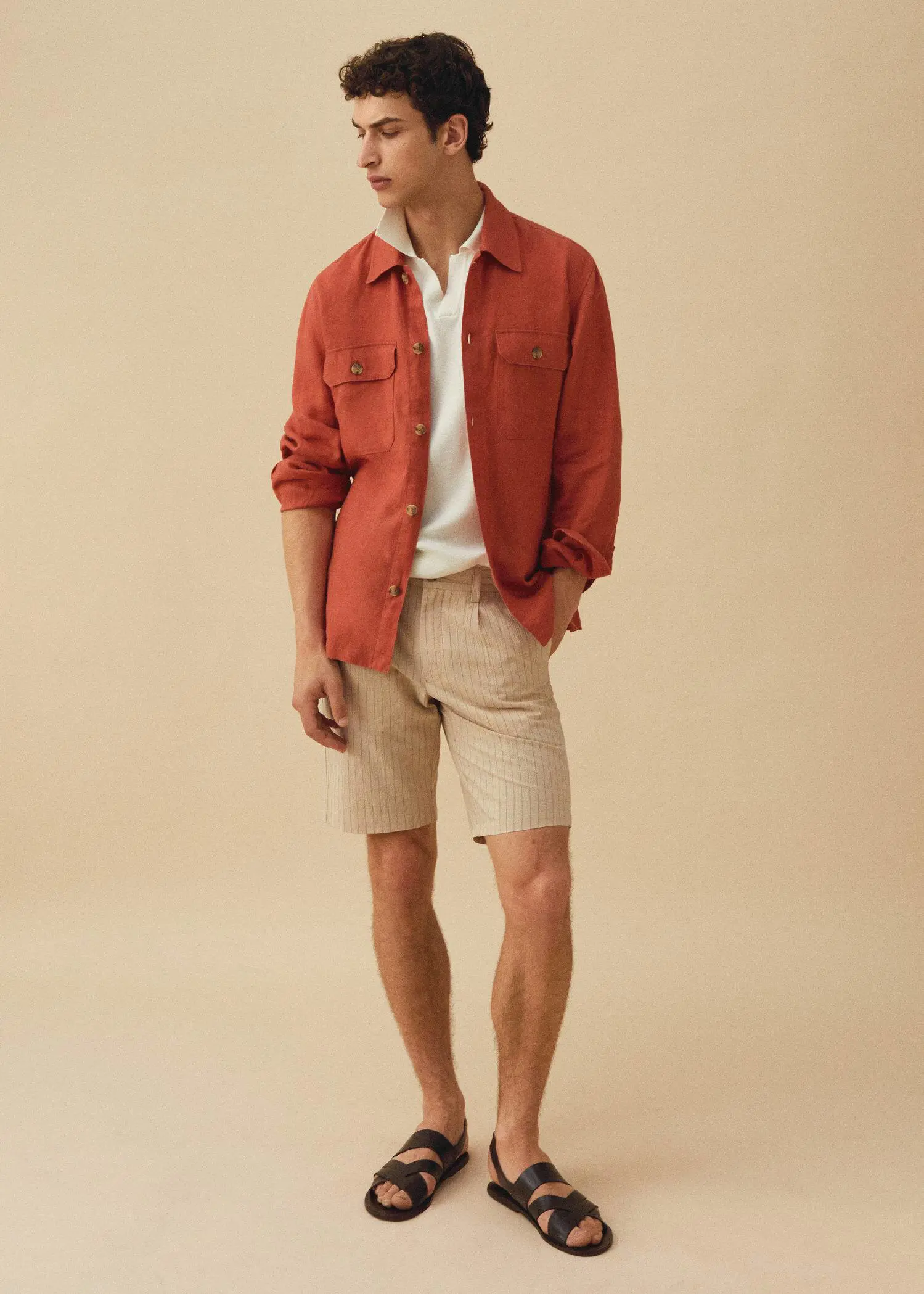 Mango Pinstripe seersucker Bermuda shorts. a man in a red shirt and beige shorts. 