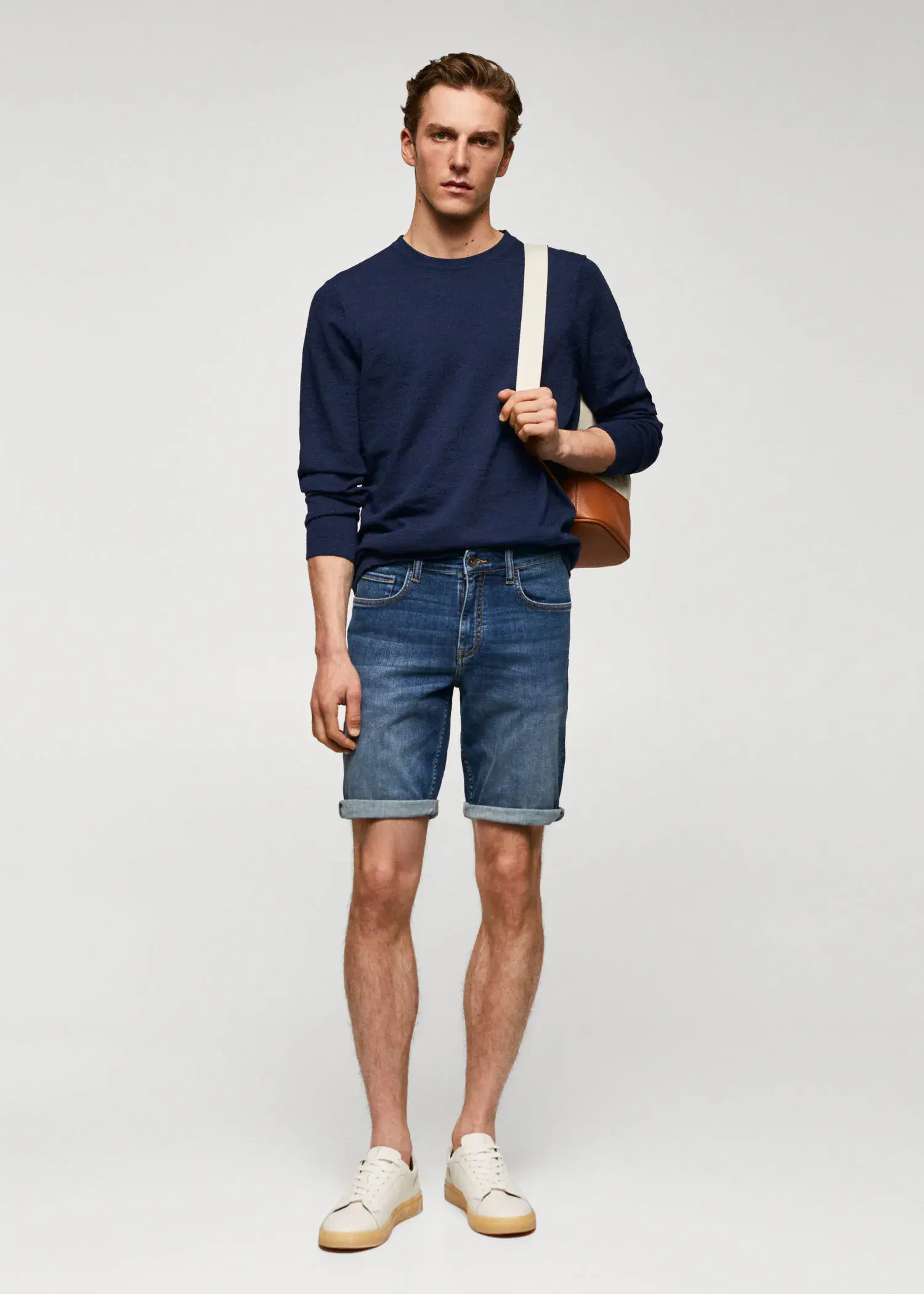 Mango Slim-fit denim bermuda shorts. a man in blue shorts and a blue sweater. 