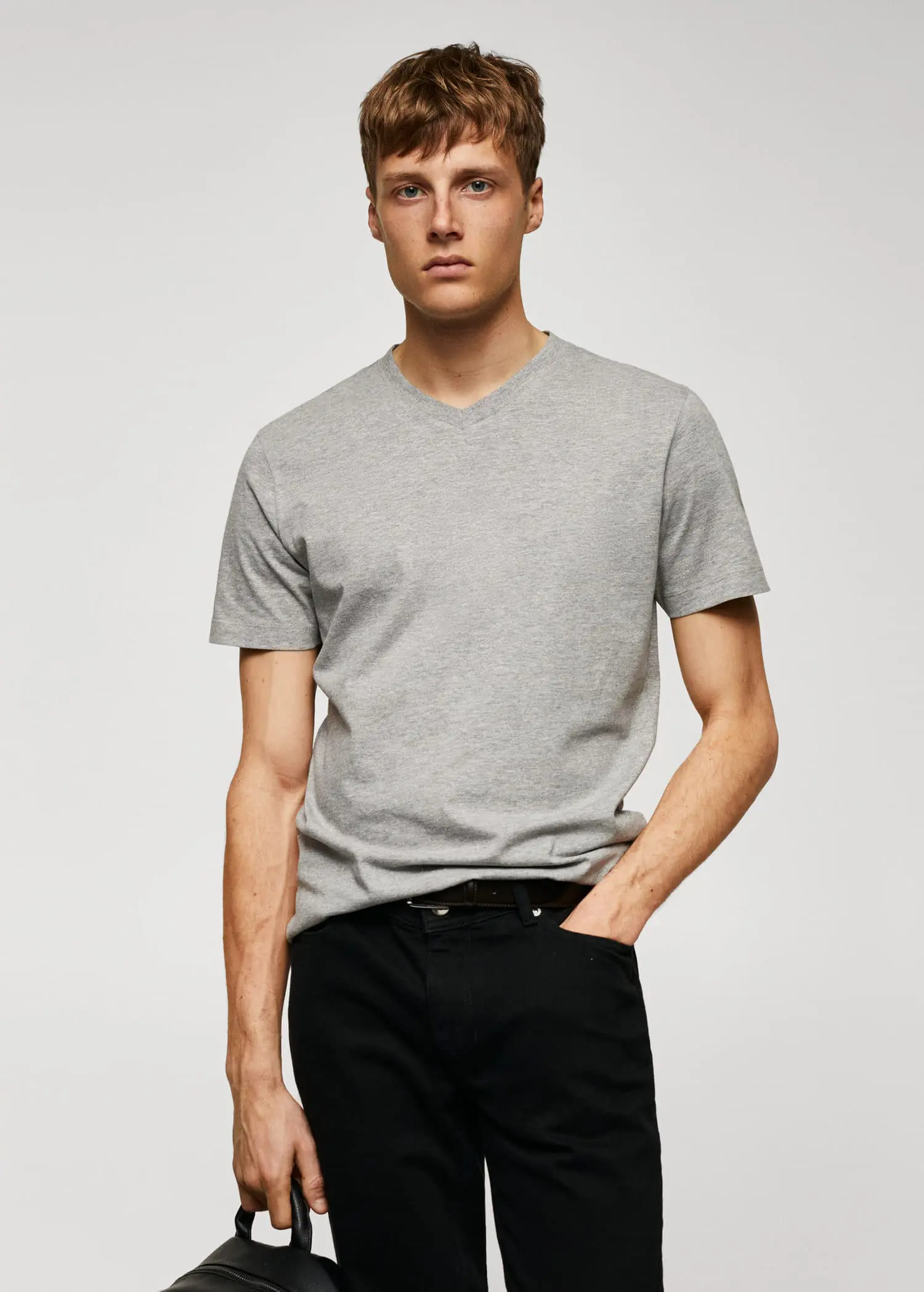 Mango Basic cotton V-neck T-shirt. a man wearing a gray t-shirt and black pants. 
