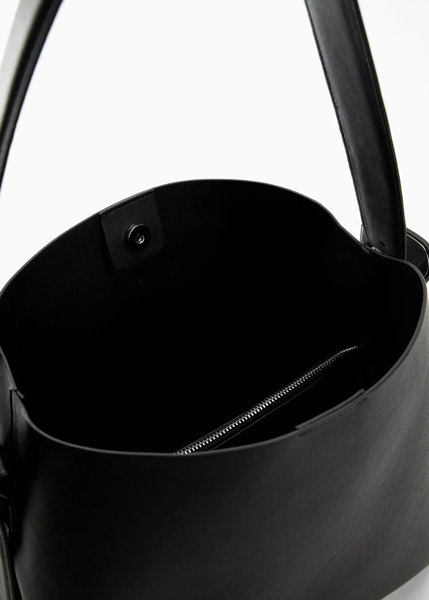Mango Shopper bag with buckle. a close-up view of the inside of a black purse. 