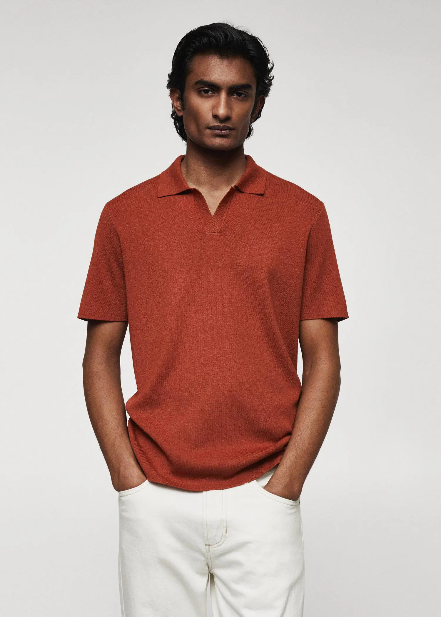 Mango Fine-knit polo shirt. a man wearing a red polo shirt and white pants. 