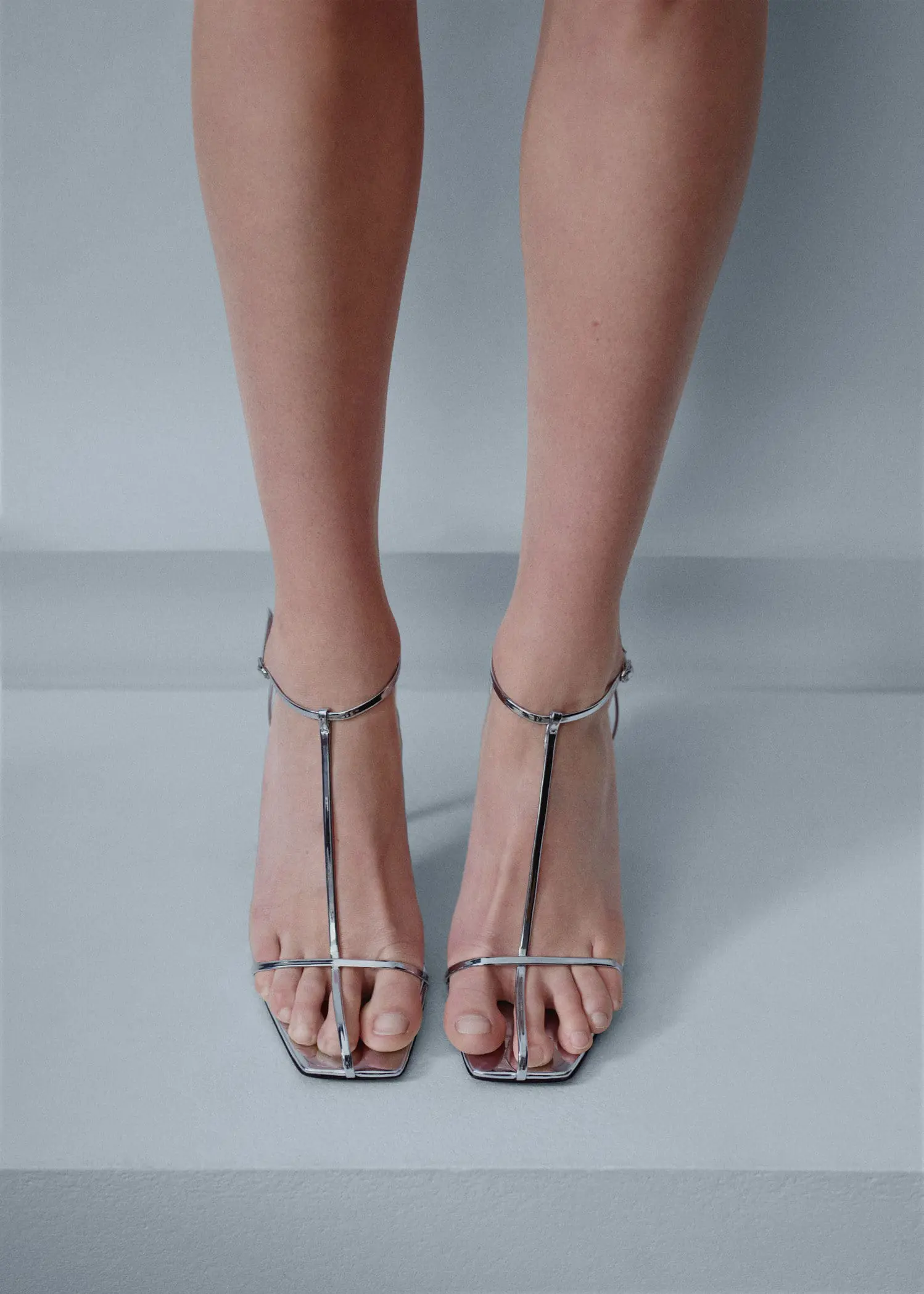 Mango Heeled leather sandals with straps. a pair of feet wearing high heel sandals. 