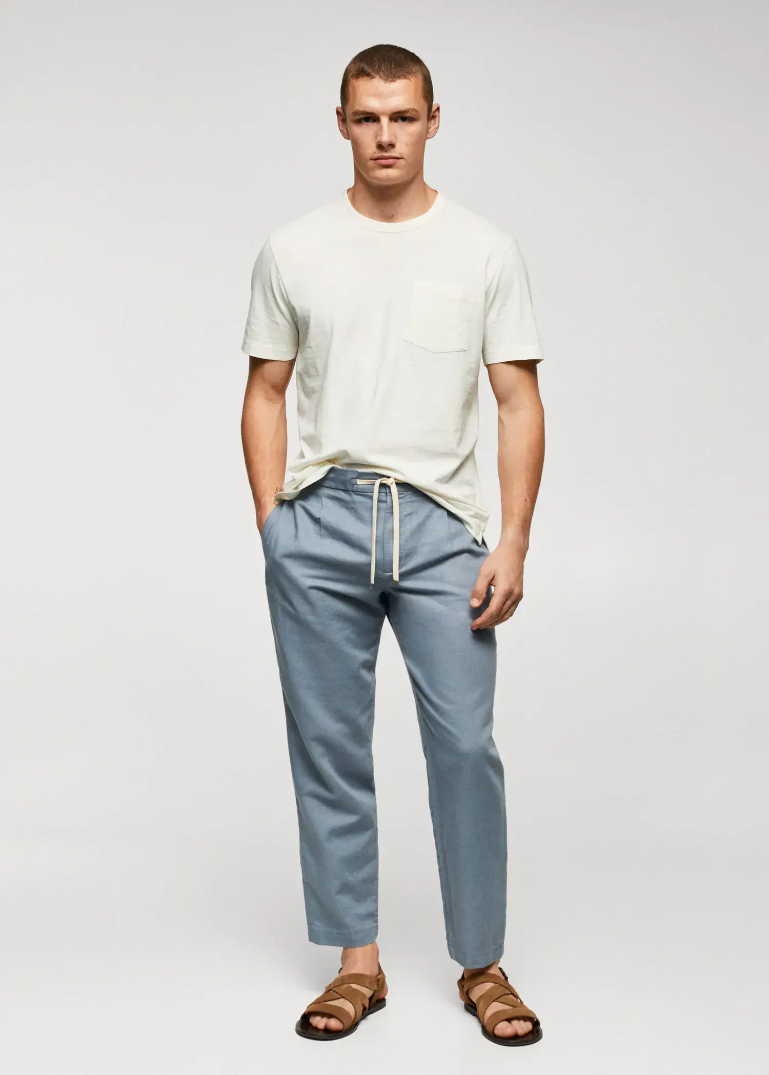 Mango 100% cotton t-shirt with pocket. a man in a white t-shirt and blue pants. 