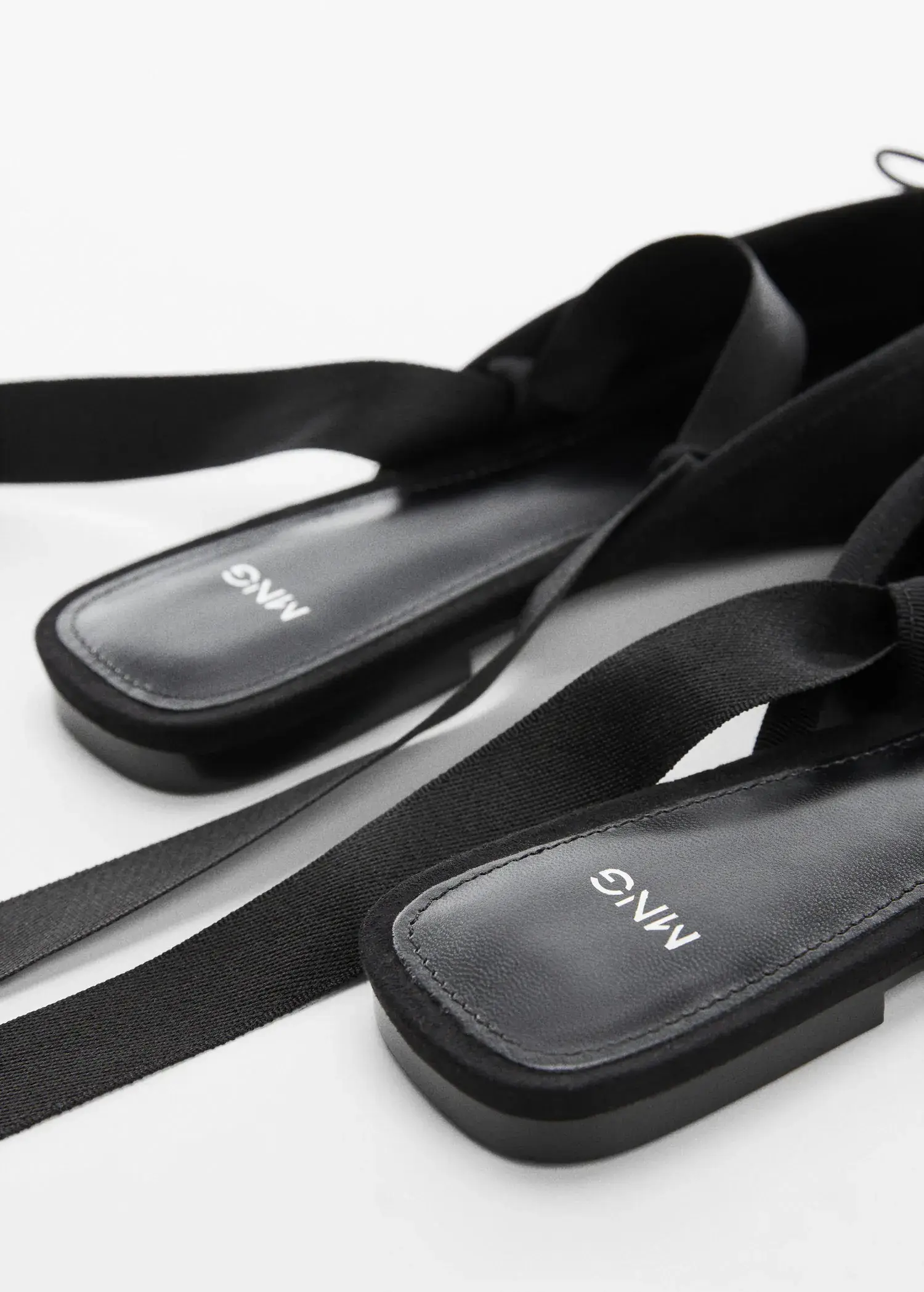 Mango Lace-up ballerinas. a close up of a pair of black sandals 