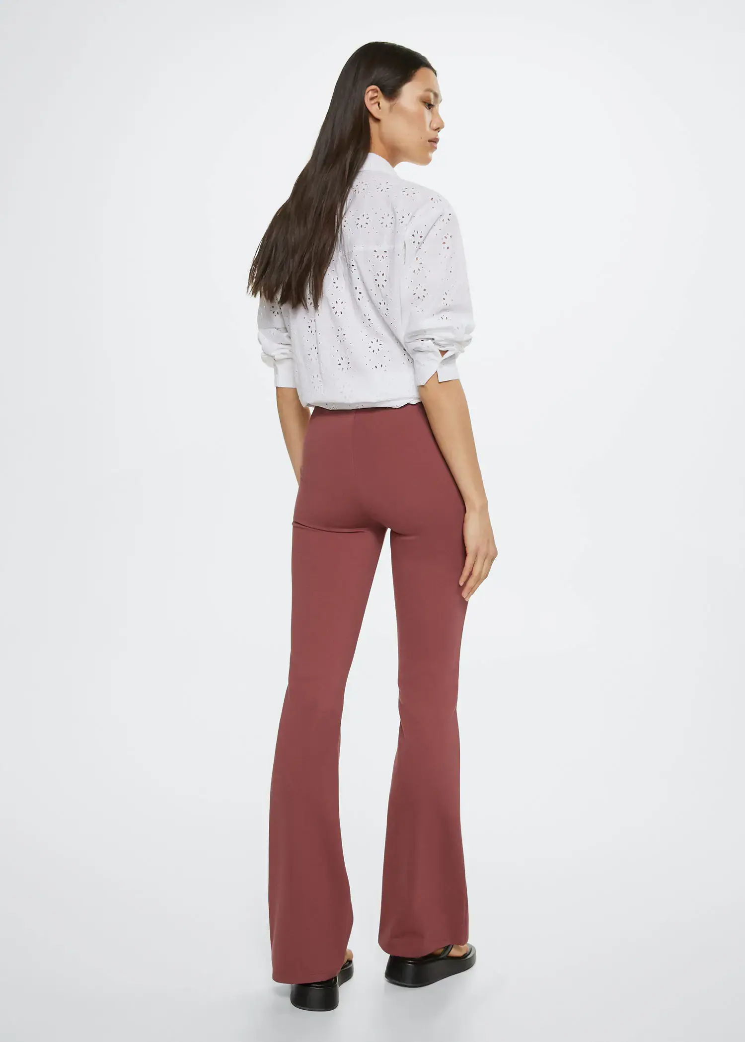 Mango Flared leggings. a woman is standing in front of a white wall. 