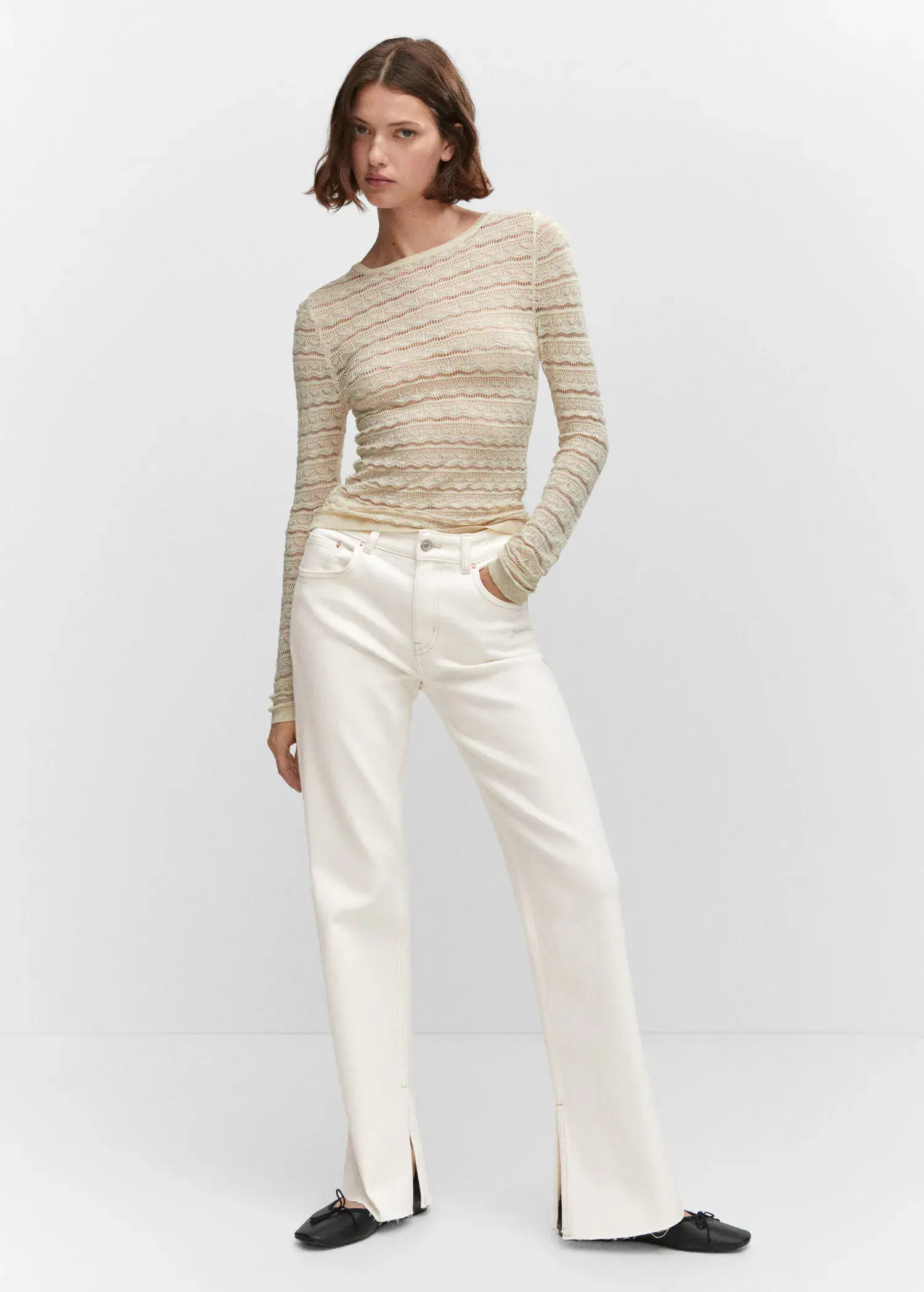 Mango Medium-rise straight jeans with slits. a woman wearing white jeans and a long sleeved shirt. 