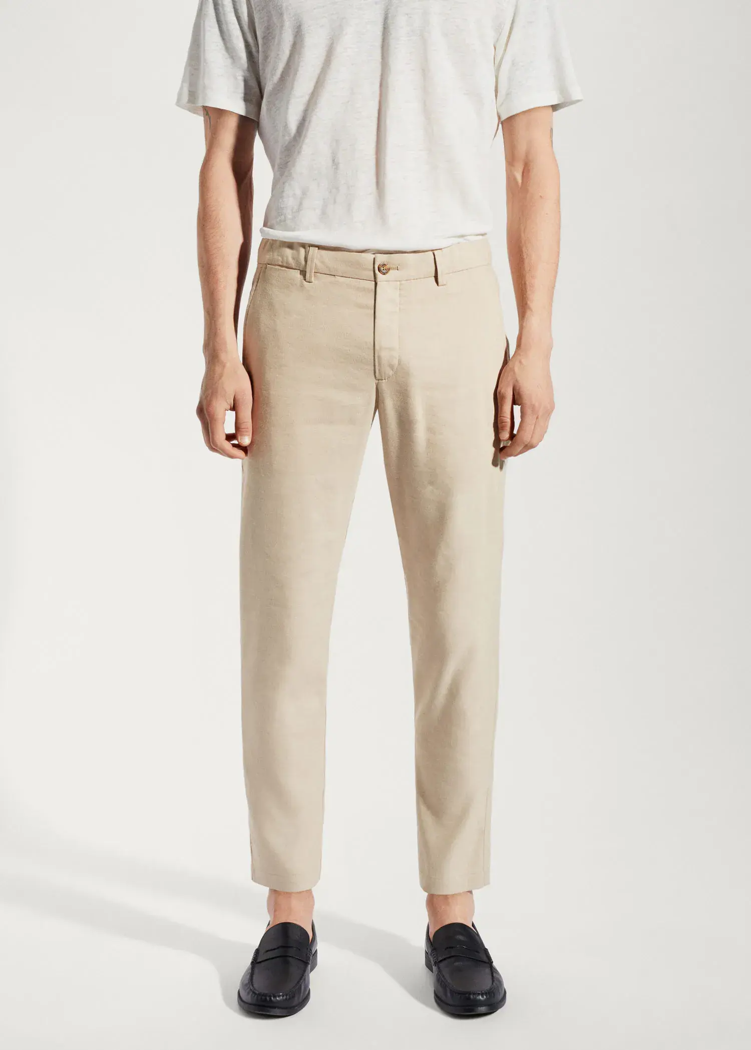 Mango Linen slim-fit pants with inner drawstring. a man wearing a white shirt and beige pants. 