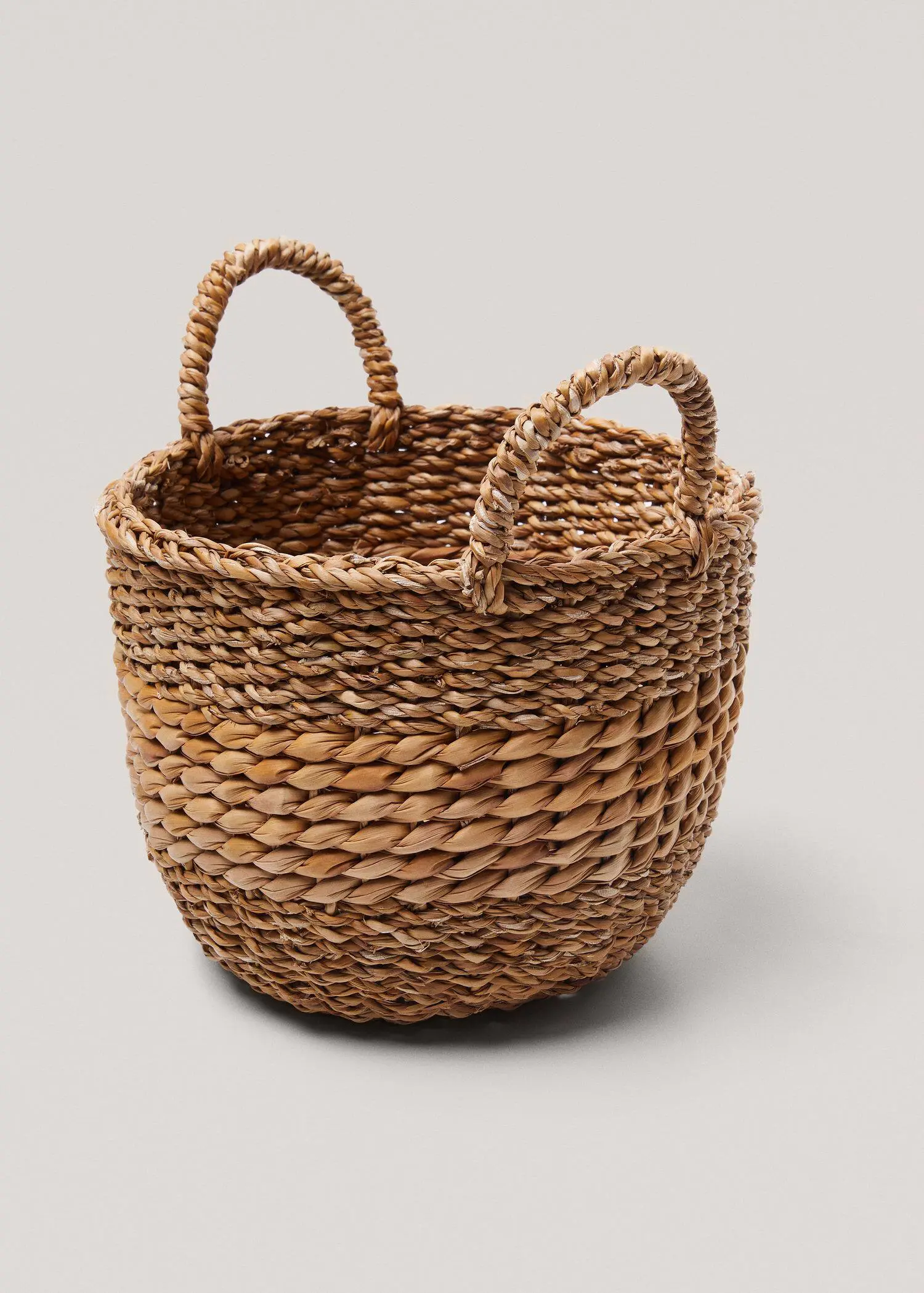 Mango Round basket 28x20x22cm. a close up of a basket on a white background 