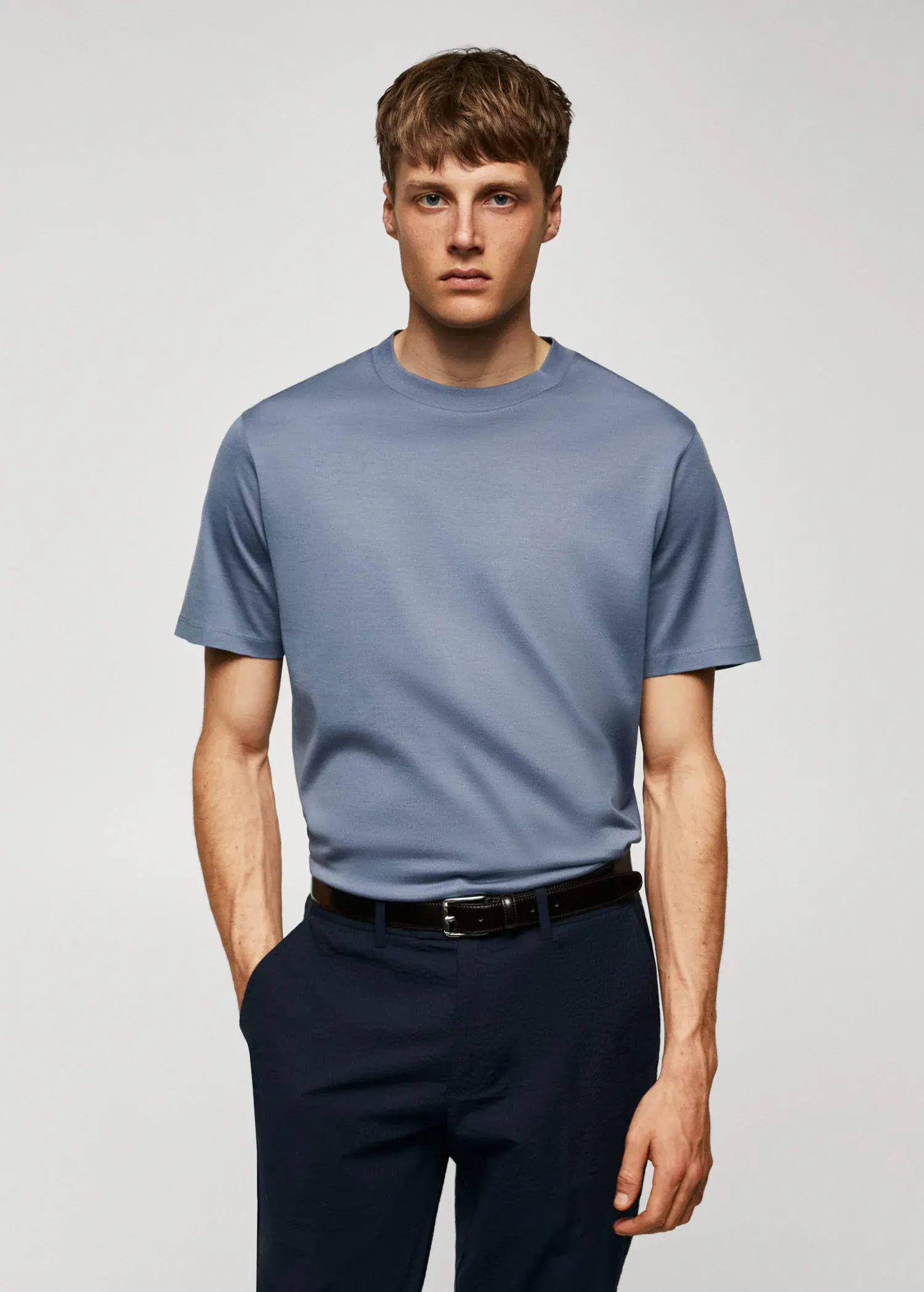 Mango Mercerized regular-fit t-shirt. a man wearing a blue shirt and black pants. 