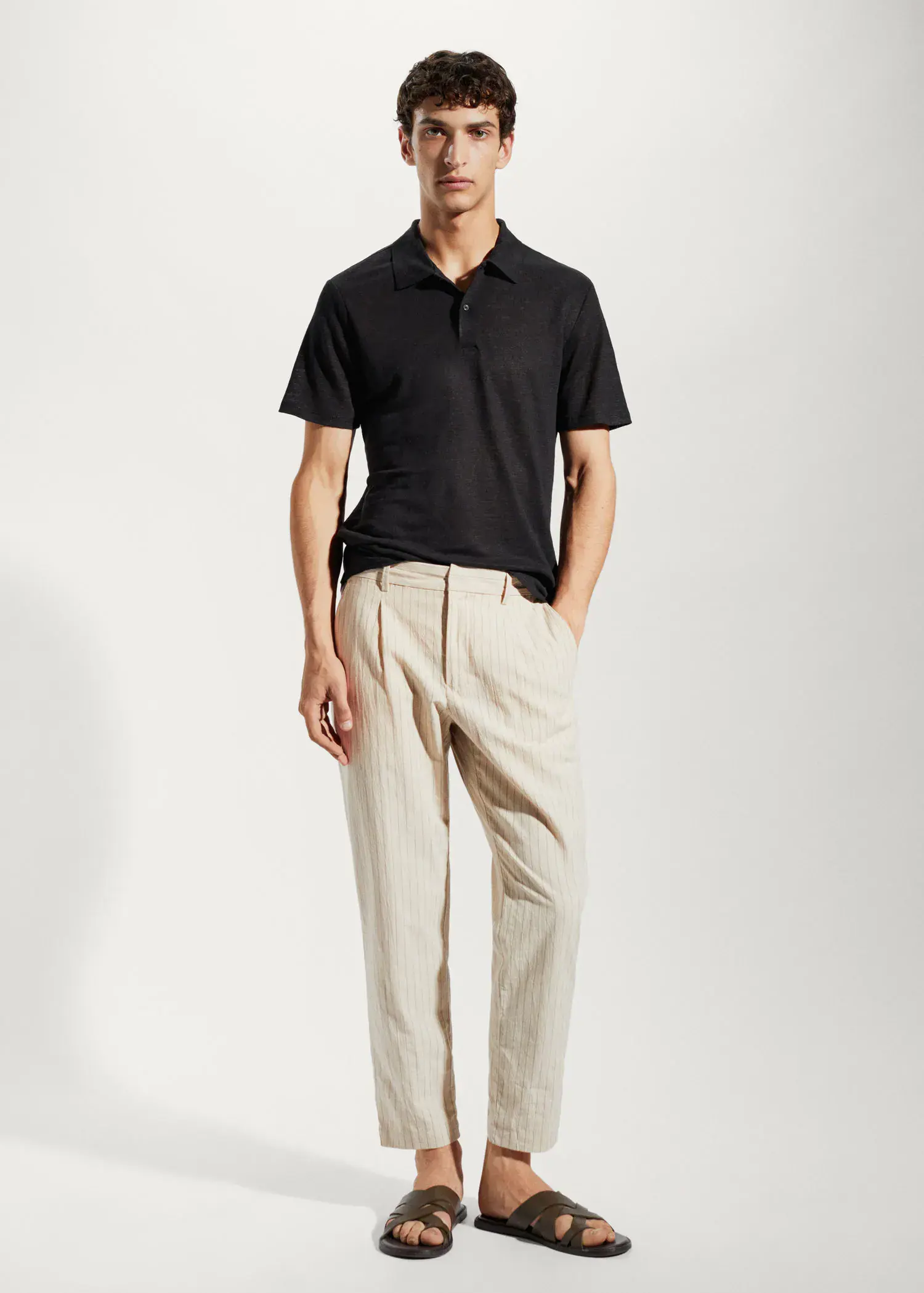 Mango Slim fit 100% linen polo shirt. a man in a black shirt and beige pants. 