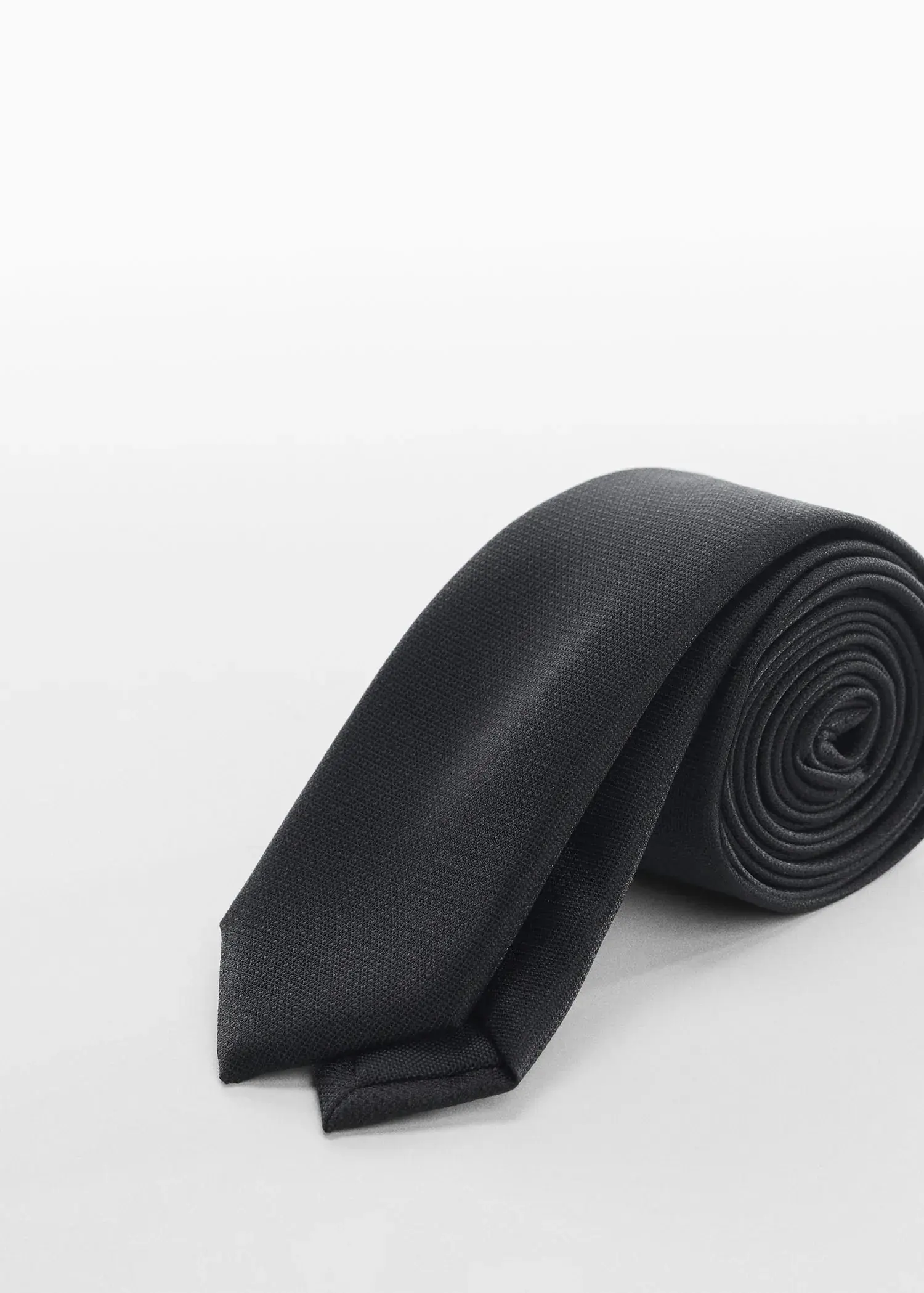Mango Narrow structured tie. a close up of a tie on a white surface 