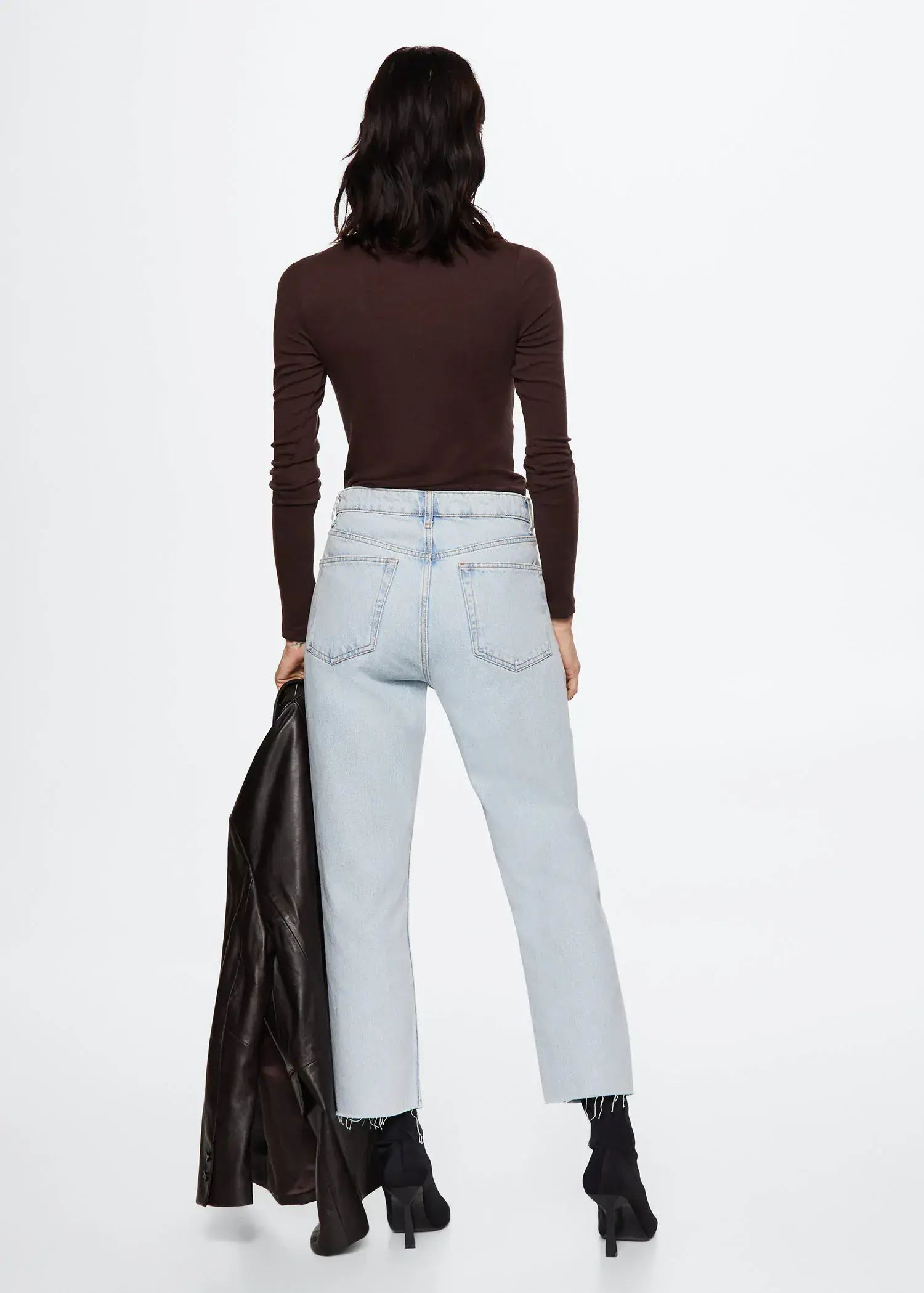 Mango High-waist cropped straight jeans. a woman holding onto a jacket and wearing jeans. 