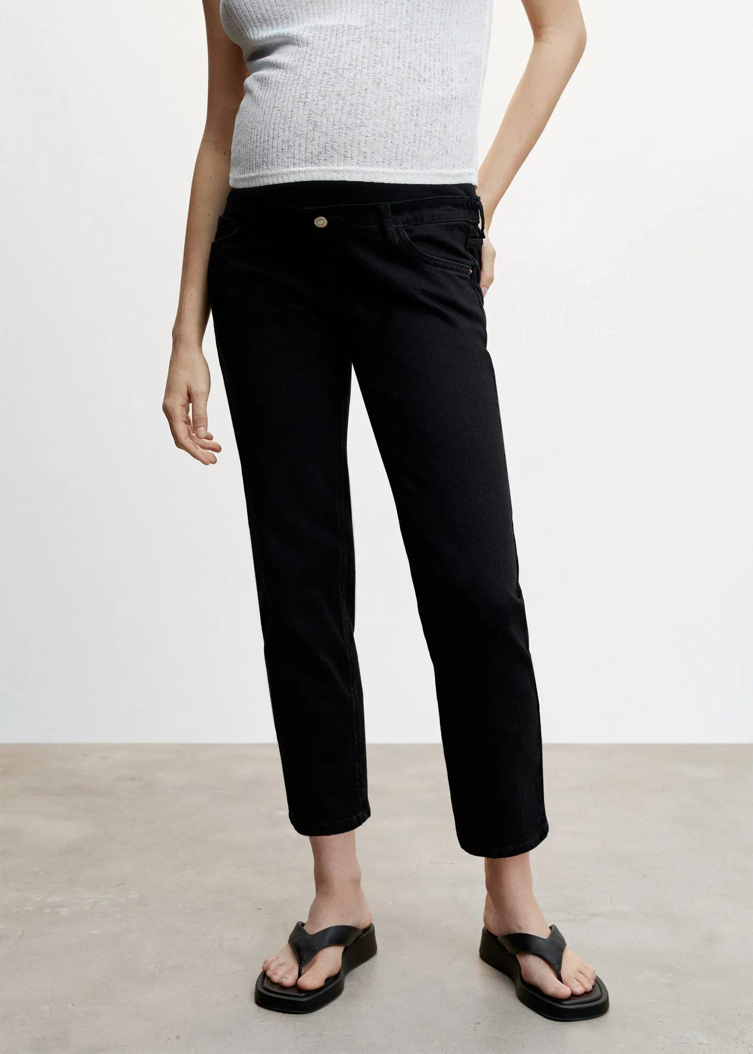 Mango Maternity Straight Jeans. a person standing in a room wearing black pants. 