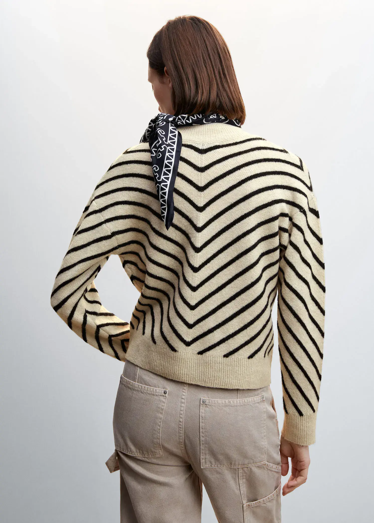 Mango Stripe-print sweater with Perkins neck. a woman wearing a black and white striped sweater. 