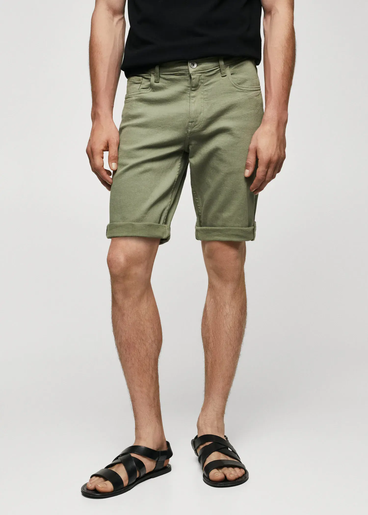 Mango Slim-fit denim bermuda shorts. a person wearing a pair of green shorts. 